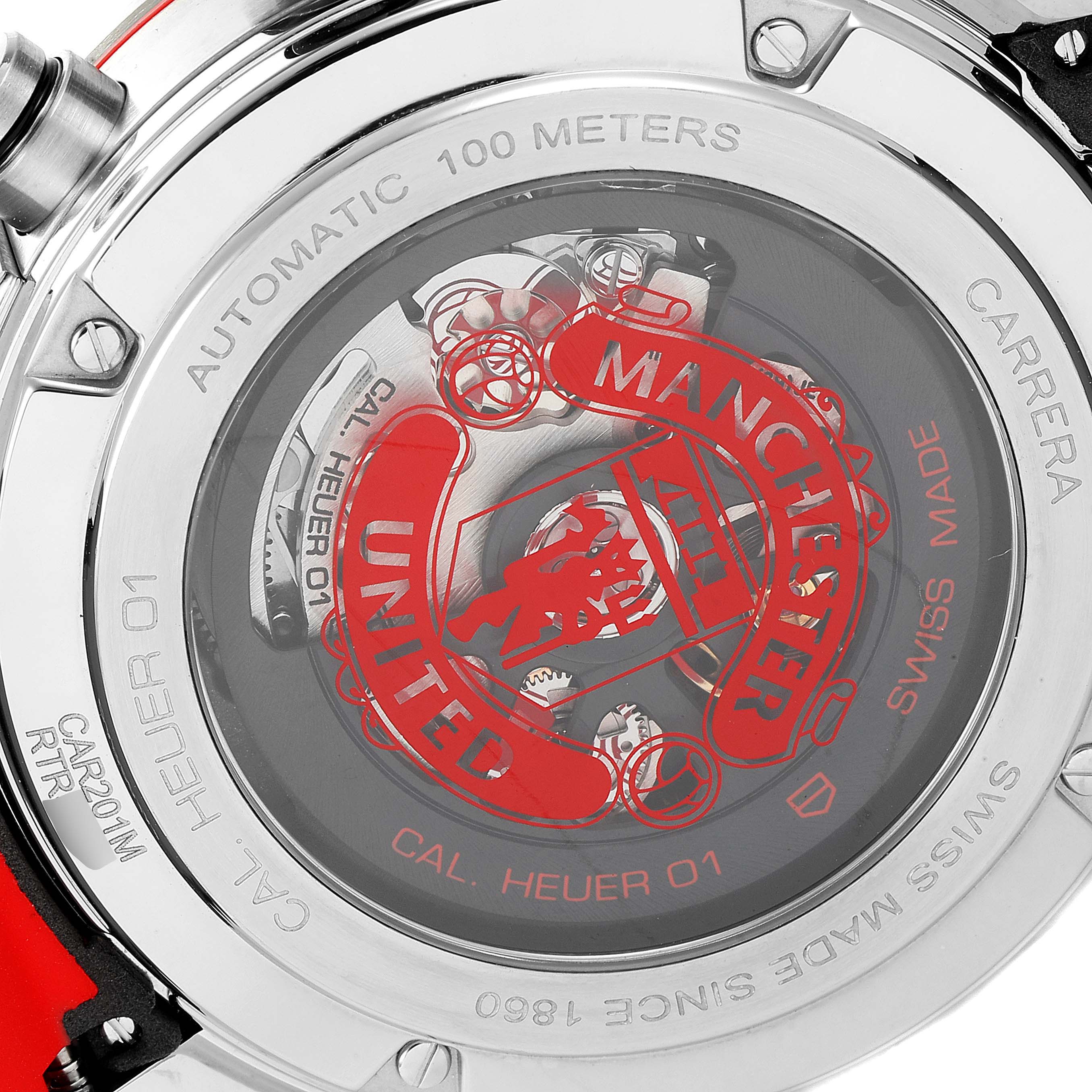 This image shows the back view of a Tag Heuer Carrera CAR201M.FT6156 Men's Stainless Steel Silver Dial CAR201M.FT6156 Men's Stainless Steel Silver Dial watch, displaying its automatic movement and Manchester United branding.