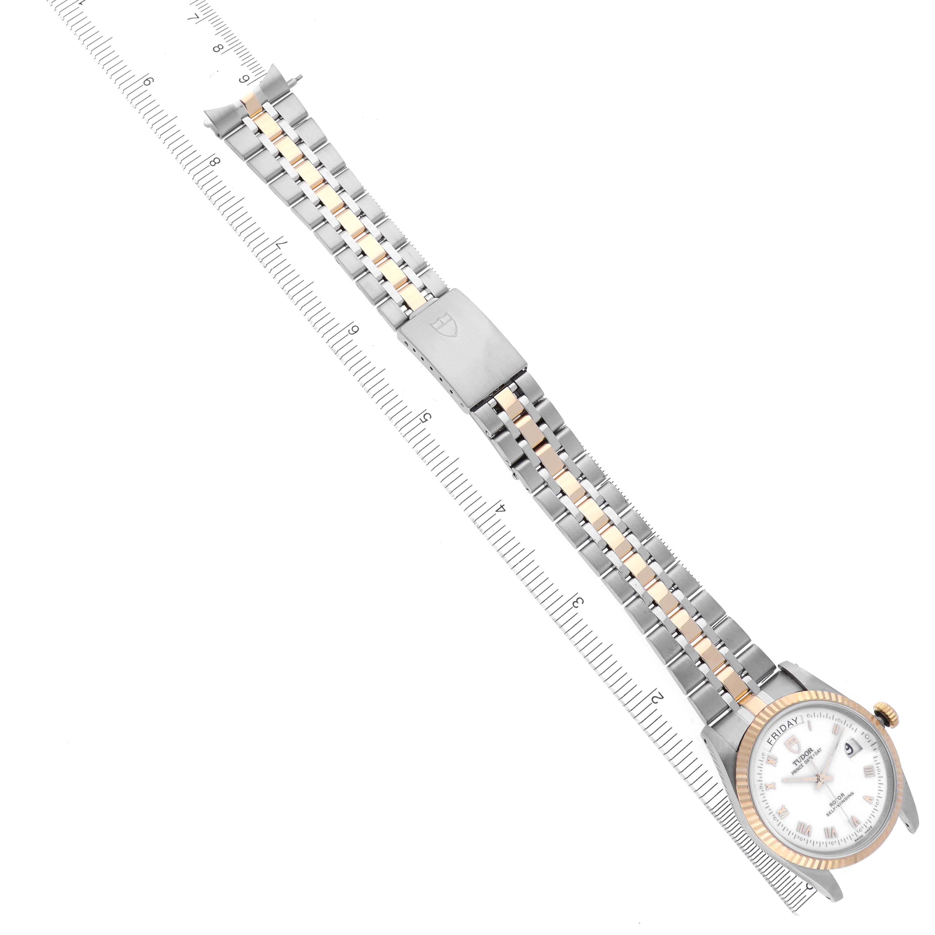 The Tudor Classic 76213 Men's Steel and Gold (two tone) White Dial 76213 Men's Steel and Gold (two tone) White Dial watch is shown at an oblique angle, displaying the dial, bracelet, and clasp alongside a ruler.