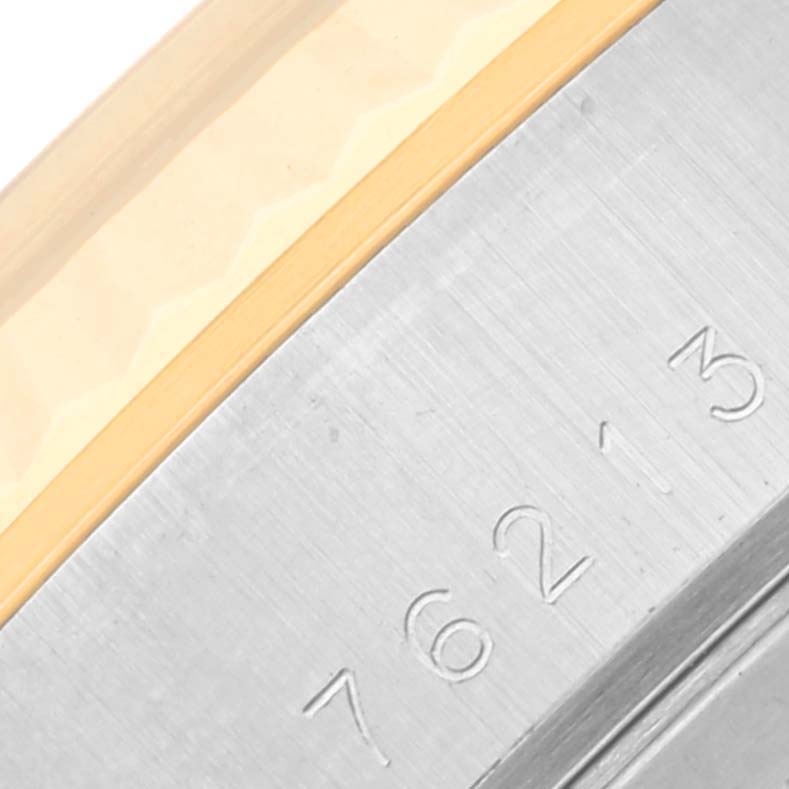 The image shows a close-up of the Tudor Classic 76213 Men's Steel and Gold (two tone) White Dial 76213 Men's Steel and Gold (two tone) White Dial model's engraved serial number on the case.