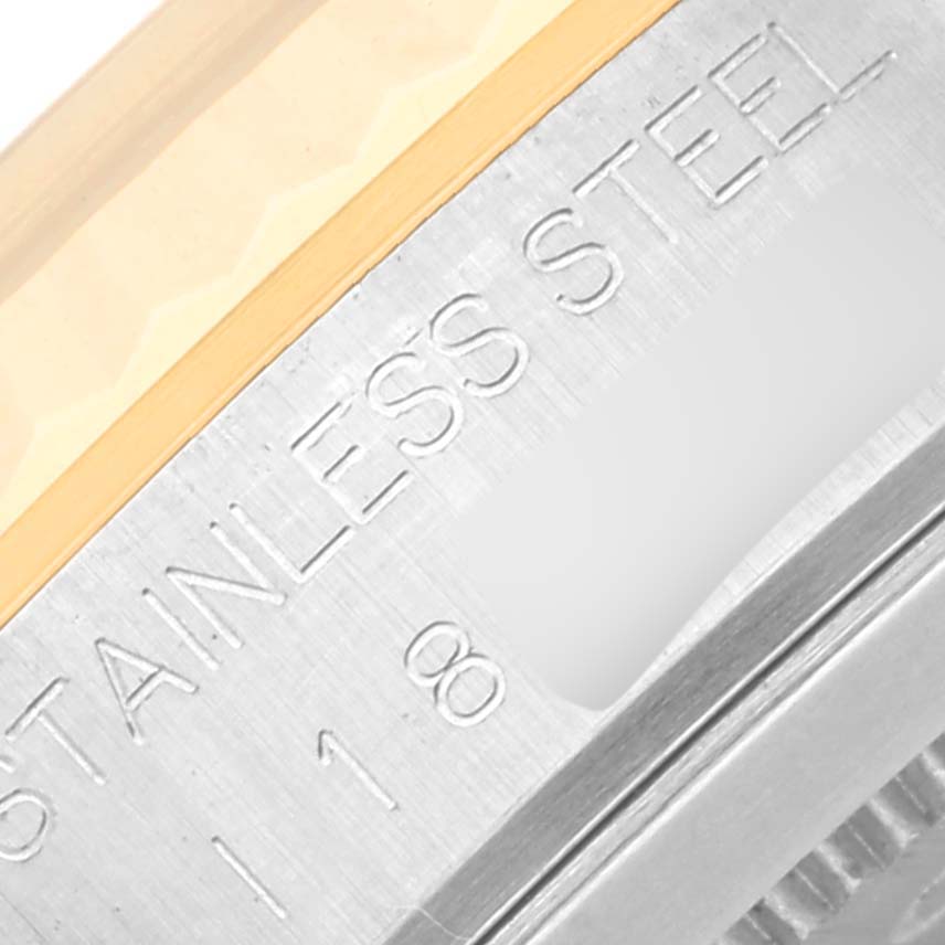 The image shows a close-up of the side of a Tudor Classic 76213 Men's Steel and Gold (two tone) White Dial 76213 Men's Steel and Gold (two tone) White Dial model watch, focusing on the stainless steel engravings.