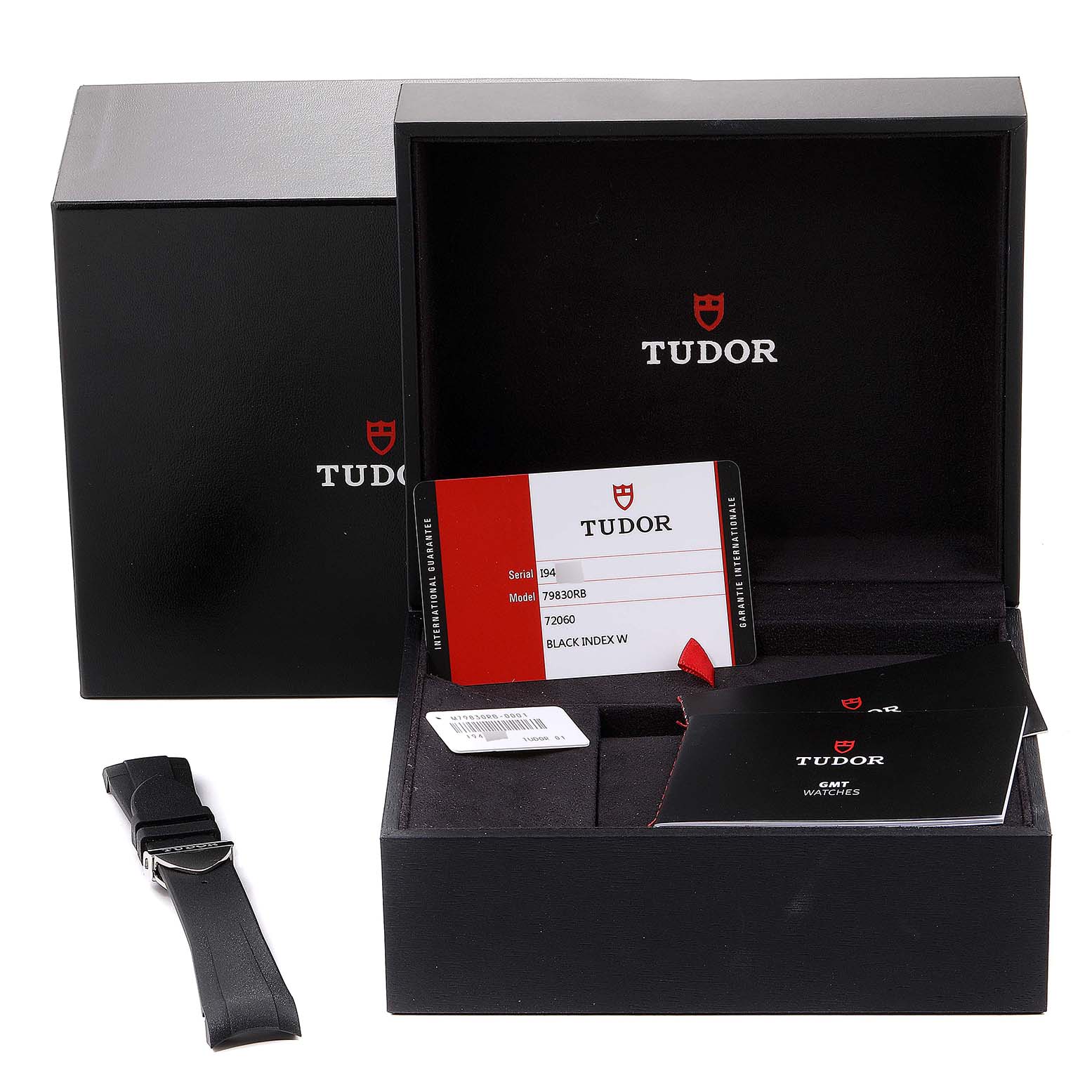 The image shows the packaging, warranty card, booklet, and spare strap for a Tudor Heritage Black Bay 79830RB Men
s Stainless Steel Black Dial 79830RB Men
s Stainless Steel Black Dial watch, model 79830RB.