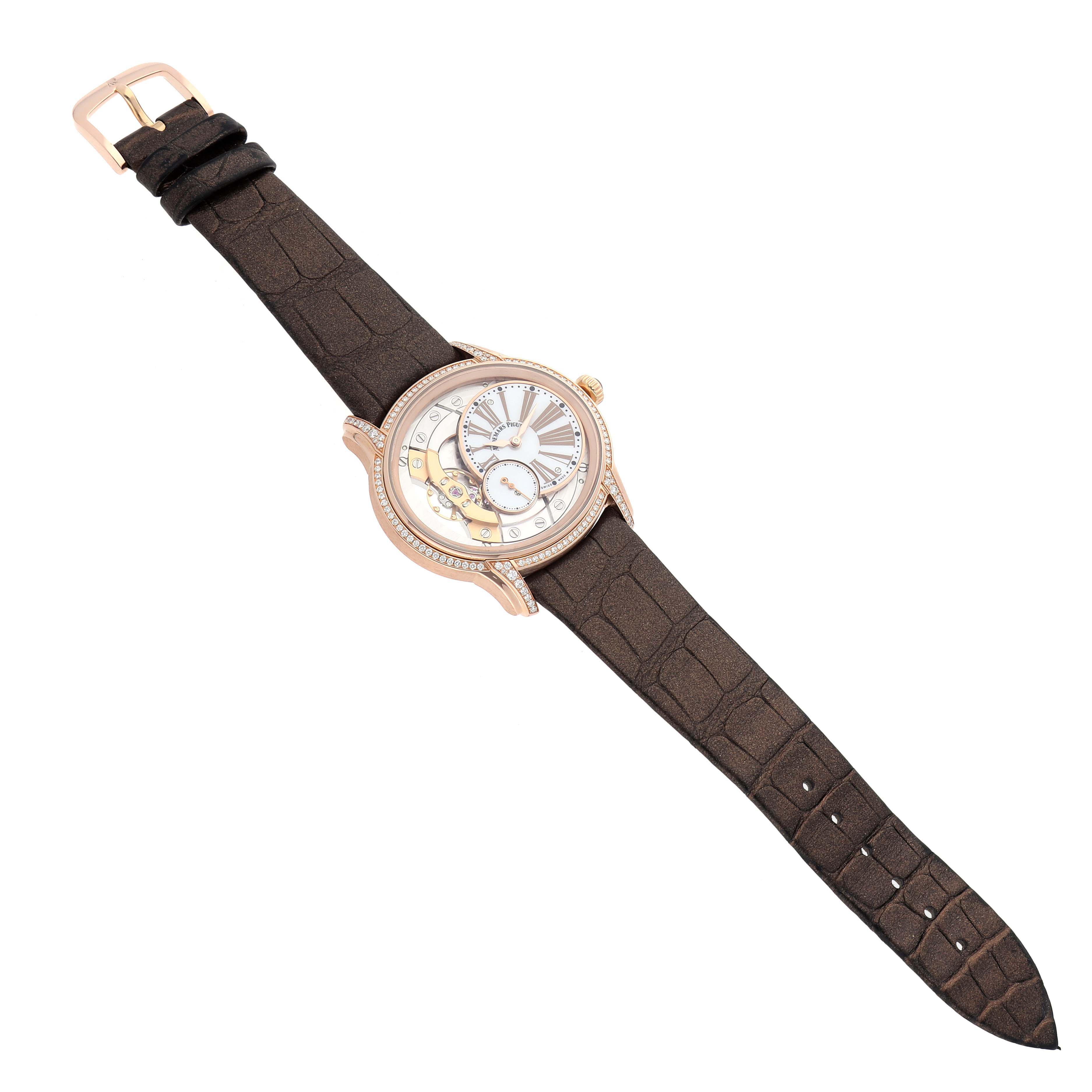 The Audemars Piguet Millenary 77247OR Women
s Rose Gold Mother of Pearl Dial watch is shown from a top view, highlighting its dial, strap, and diamond-encrusted bezel.