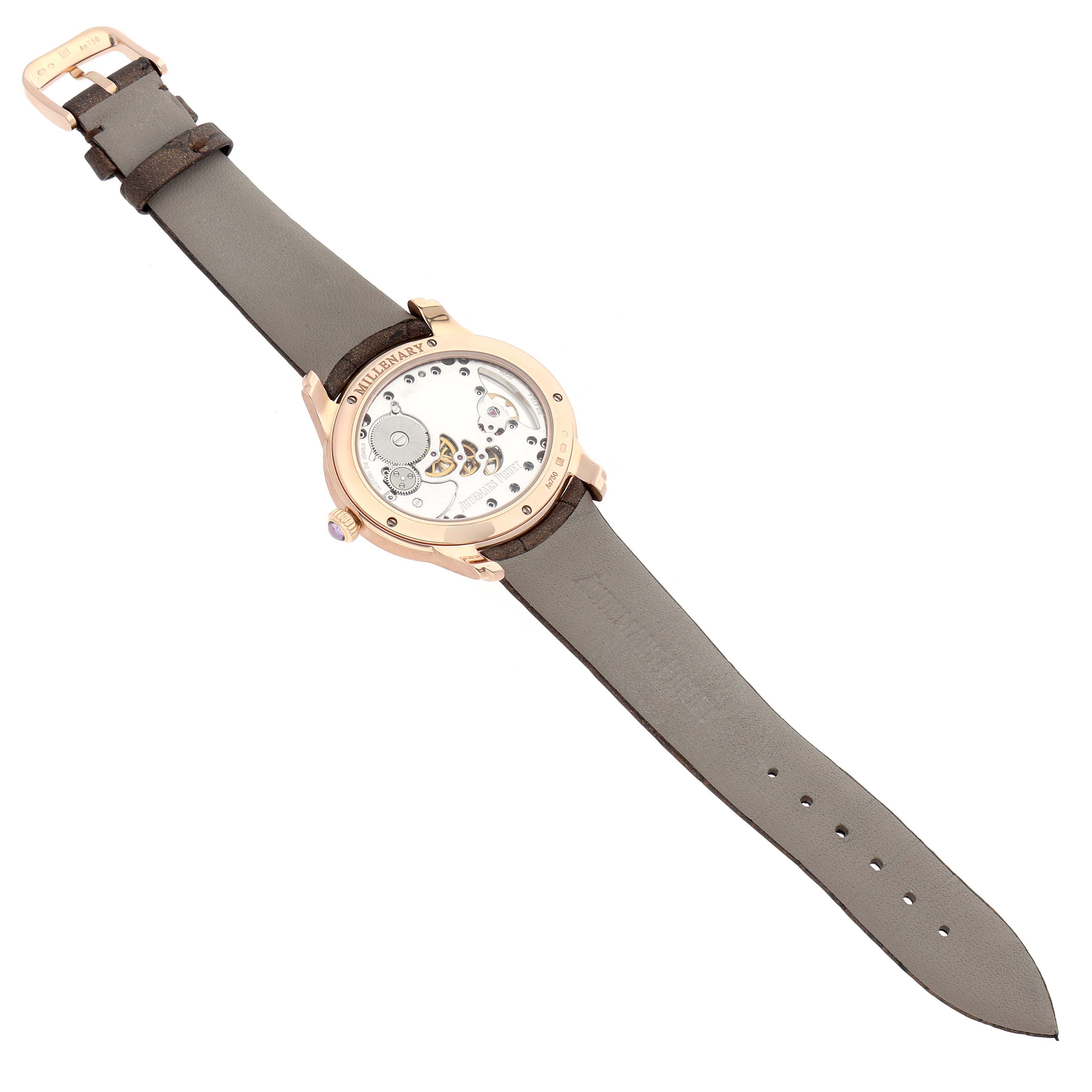 The Audemars Piguet Millenary 77247OR Women
s Rose Gold Mother of Pearl Dial watch is shown from the back angle, highlighting the exposed movement and leather strap.