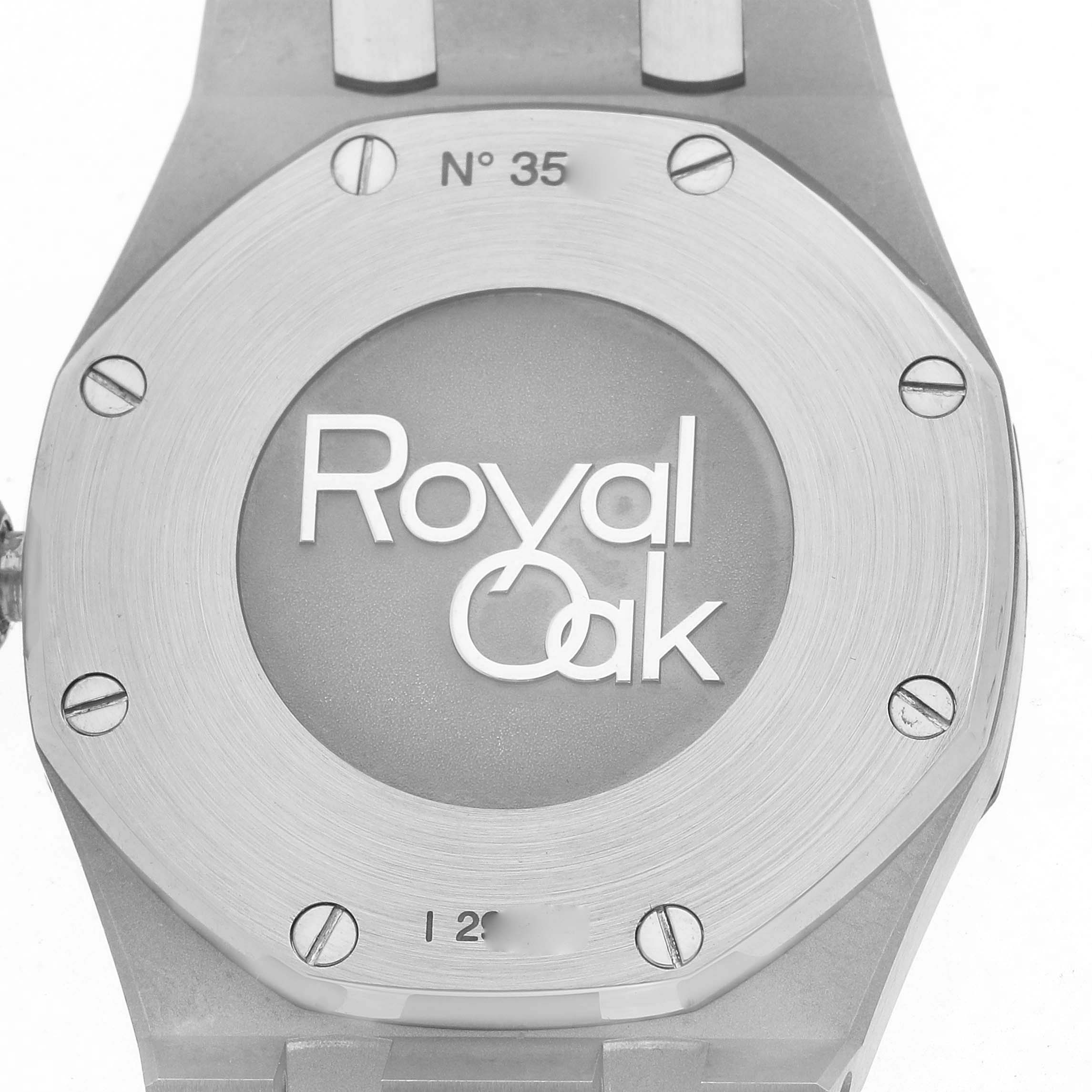 This image shows the back of an Audemars Piguet Royal Oak 67651ST Women
s Stainless Steel Silver Dial watch, highlighting the engraved logo and screws.