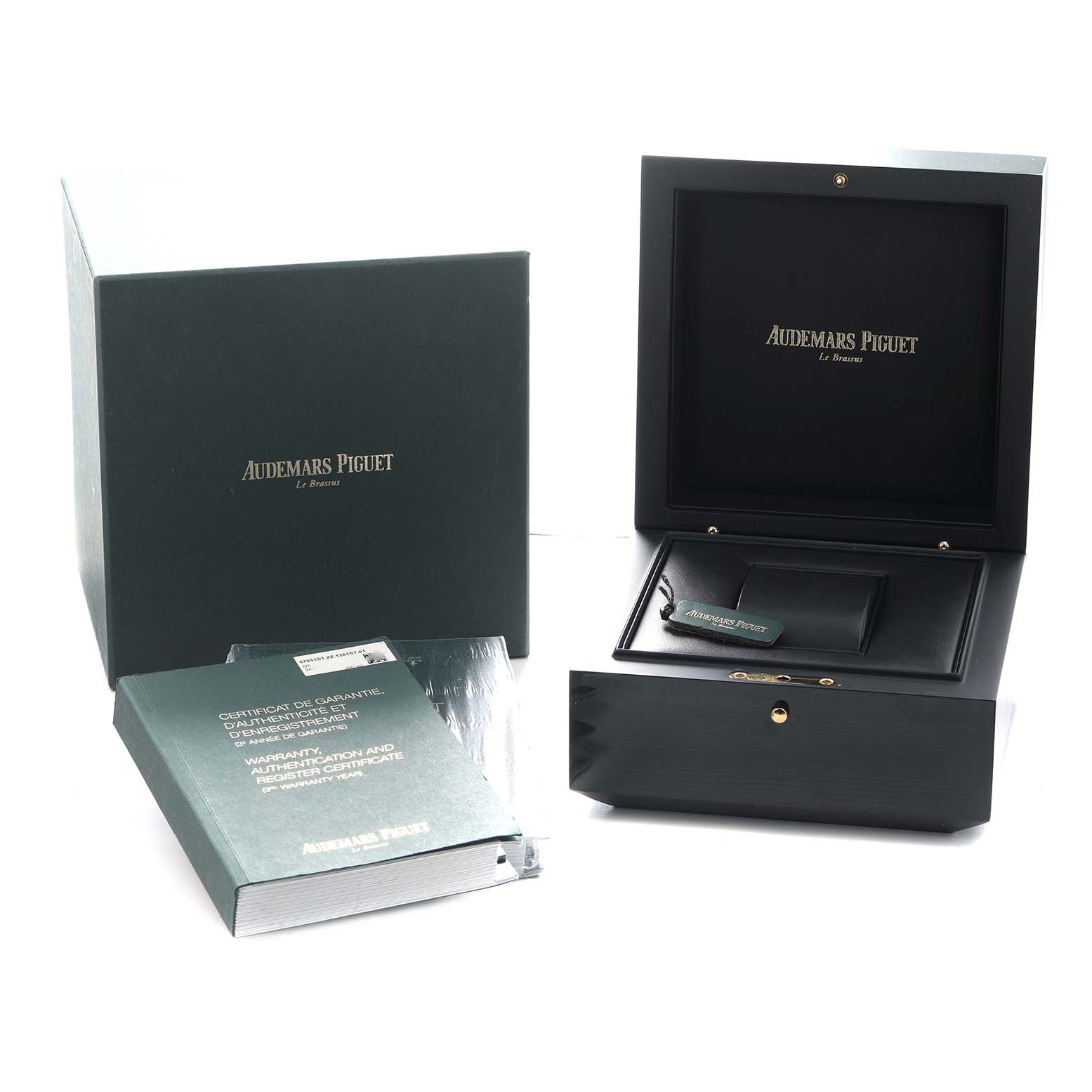 The image shows an Audemars Piguet Royal Oak 67651ST Women
s Stainless Steel Silver Dial box set, including the open watch box, papers, and outer packaging.