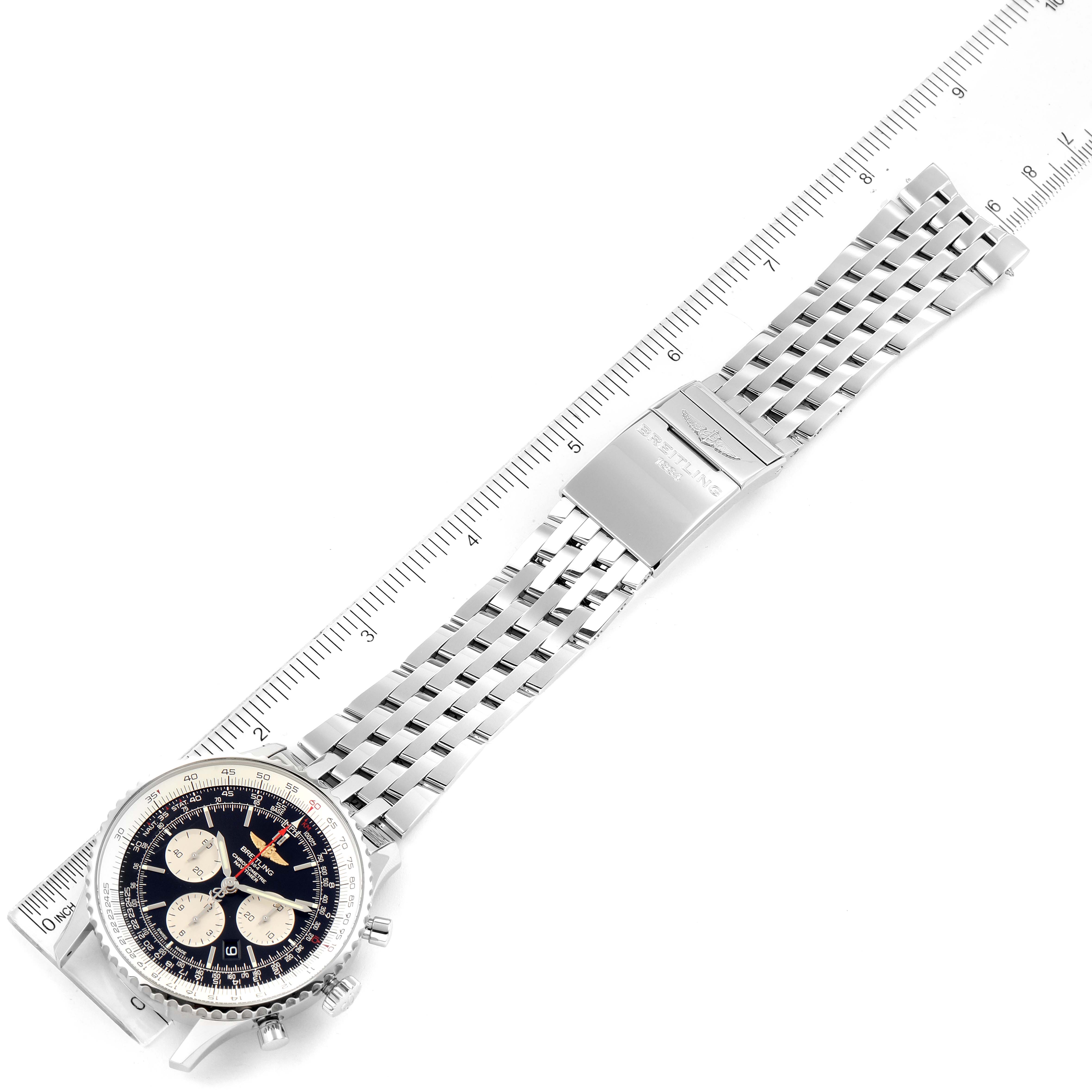 The image shows a Breitling Navitimer AB0127-211-B1A1 Men
s Stainless Steel Black Dial AB0127-211-B1A1 Men
s Stainless Steel Black Dial watch laid flat with its full stainless steel bracelet and a ruler for scale.