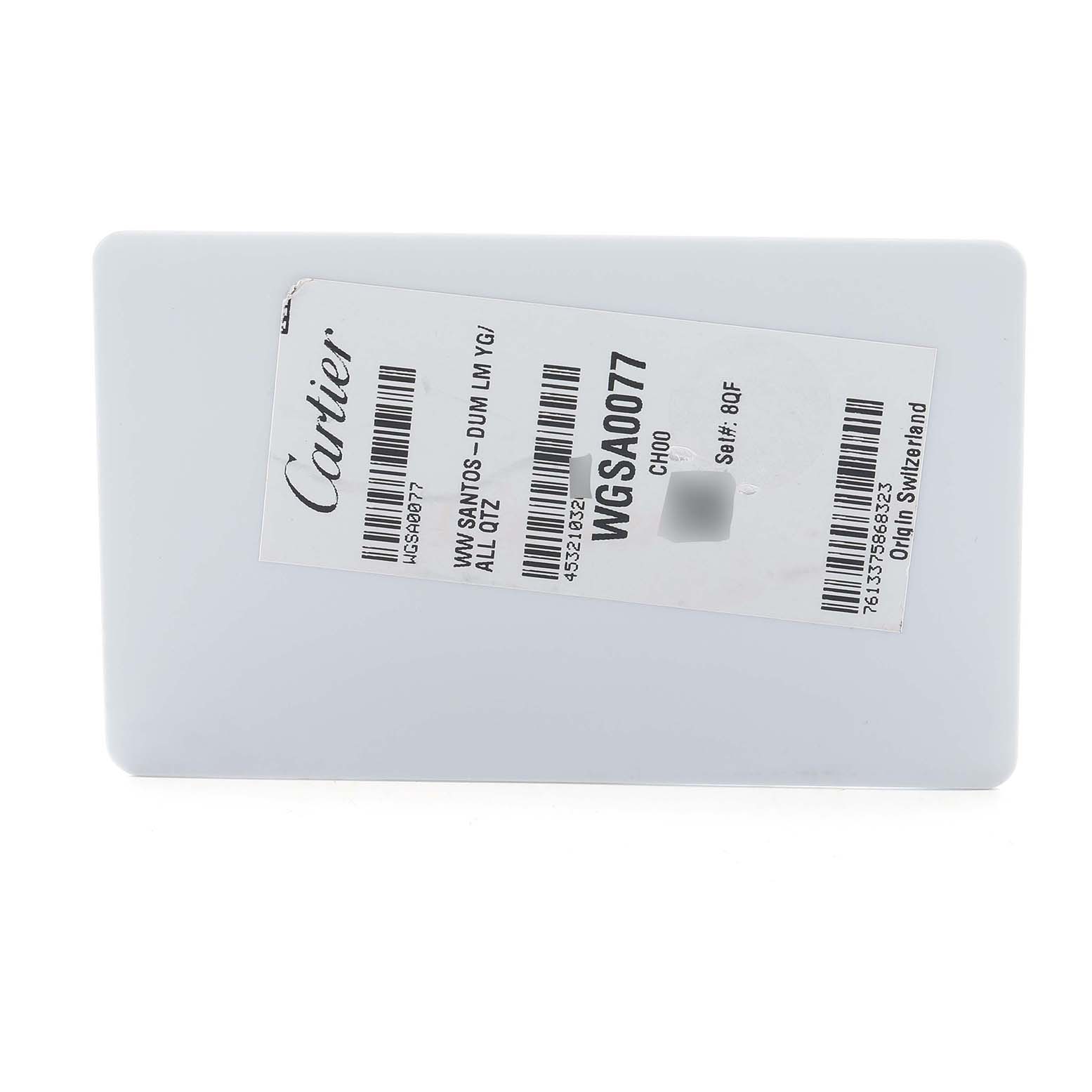 The image shows a white rectangular tag labeled with information for the Cartier Santos Dumont WGSA0077 Men
s Yellow Gold Blue Dial model.