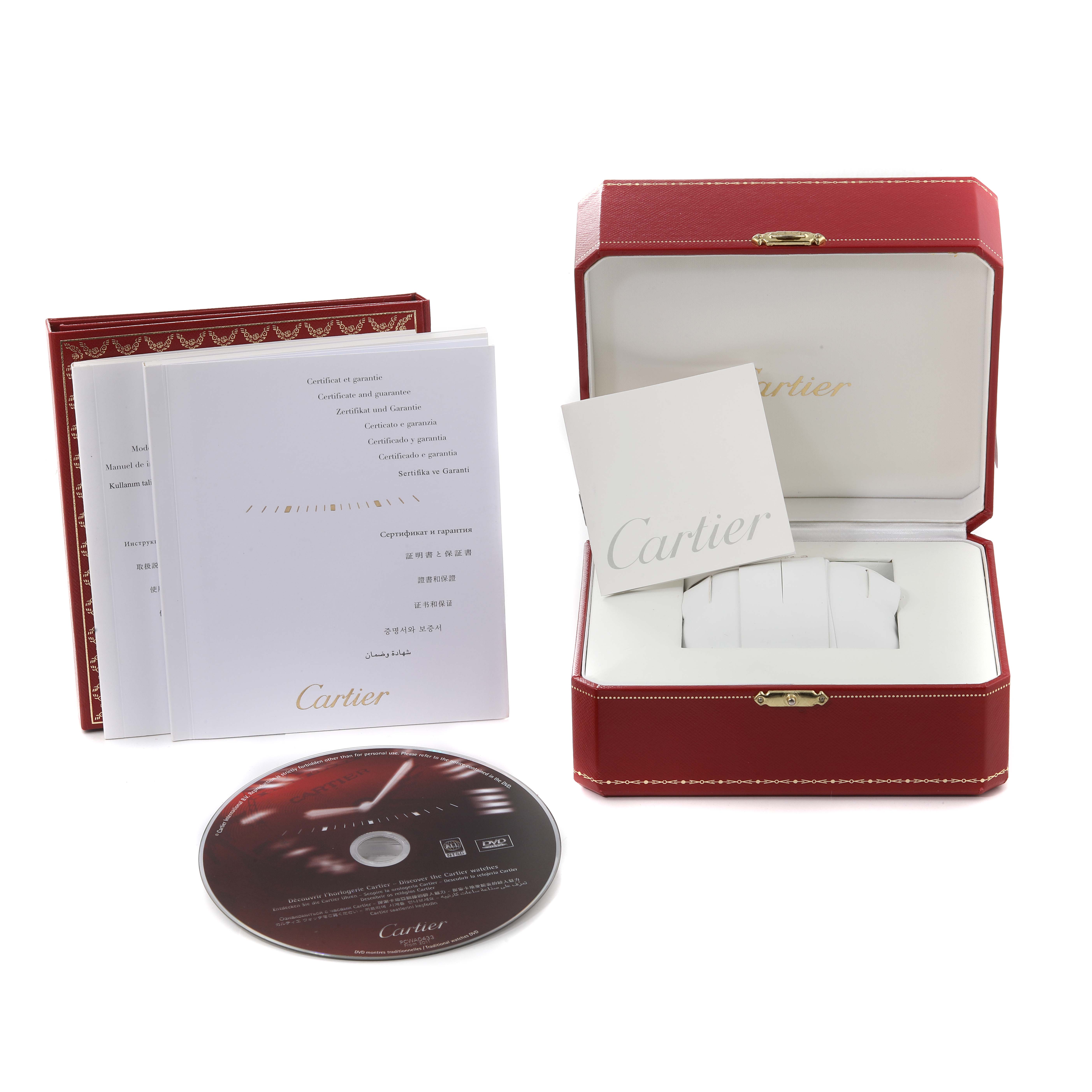 The image shows a Cartier Tank Anglaise W5310037 Men
s Steel and Gold (two tone) Silver Dial W5310037 Men
s Steel and Gold (two tone) Silver Dial watch box, booklets, and a CD, indicating accessories and packaging from the brand.