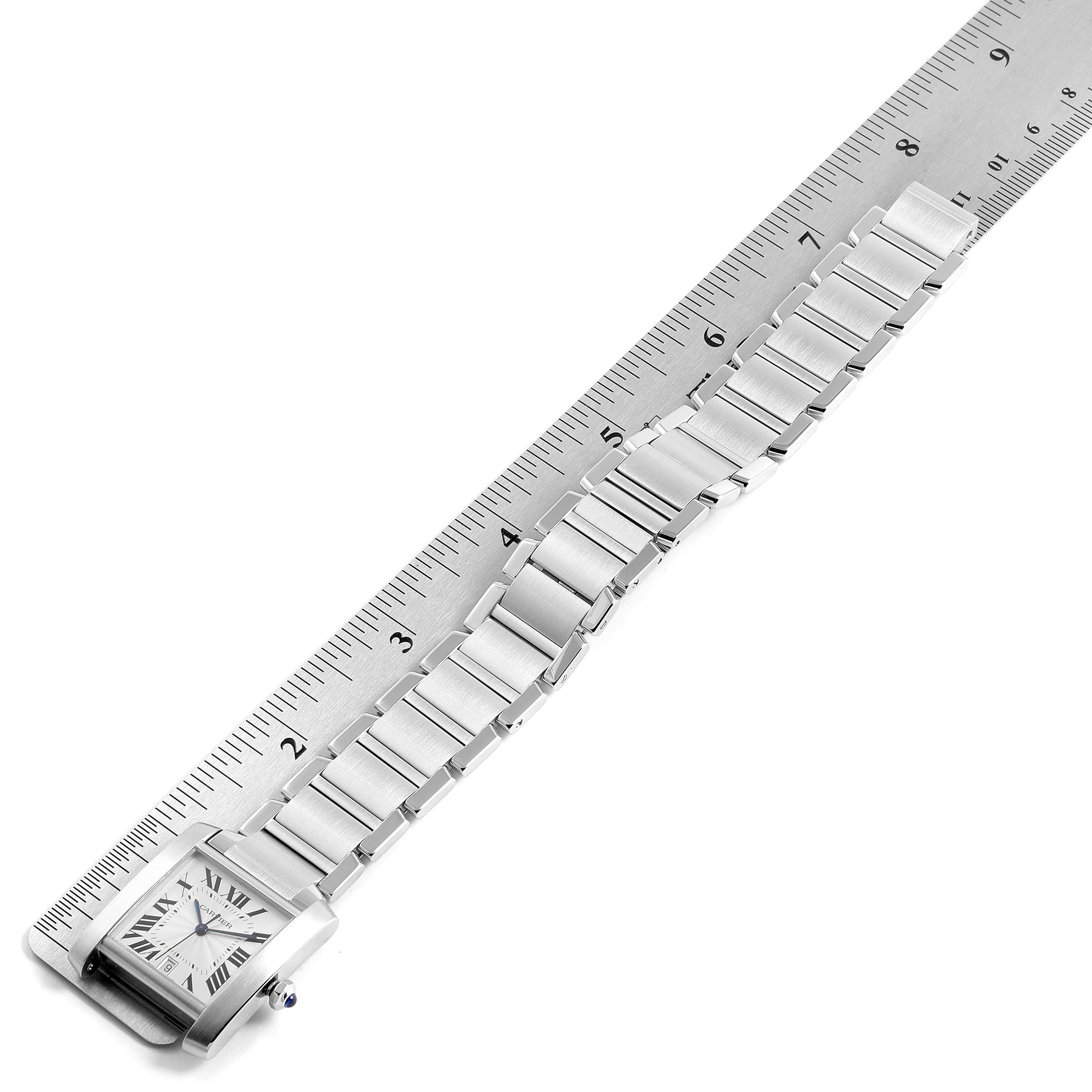 The image shows a Cartier Tank Francaise W51002Q3 Men's Stainless Steel Silver Dial W51002Q3 Men's Stainless Steel Silver Dial watch with its bracelet laid flat and measured against a ruler.