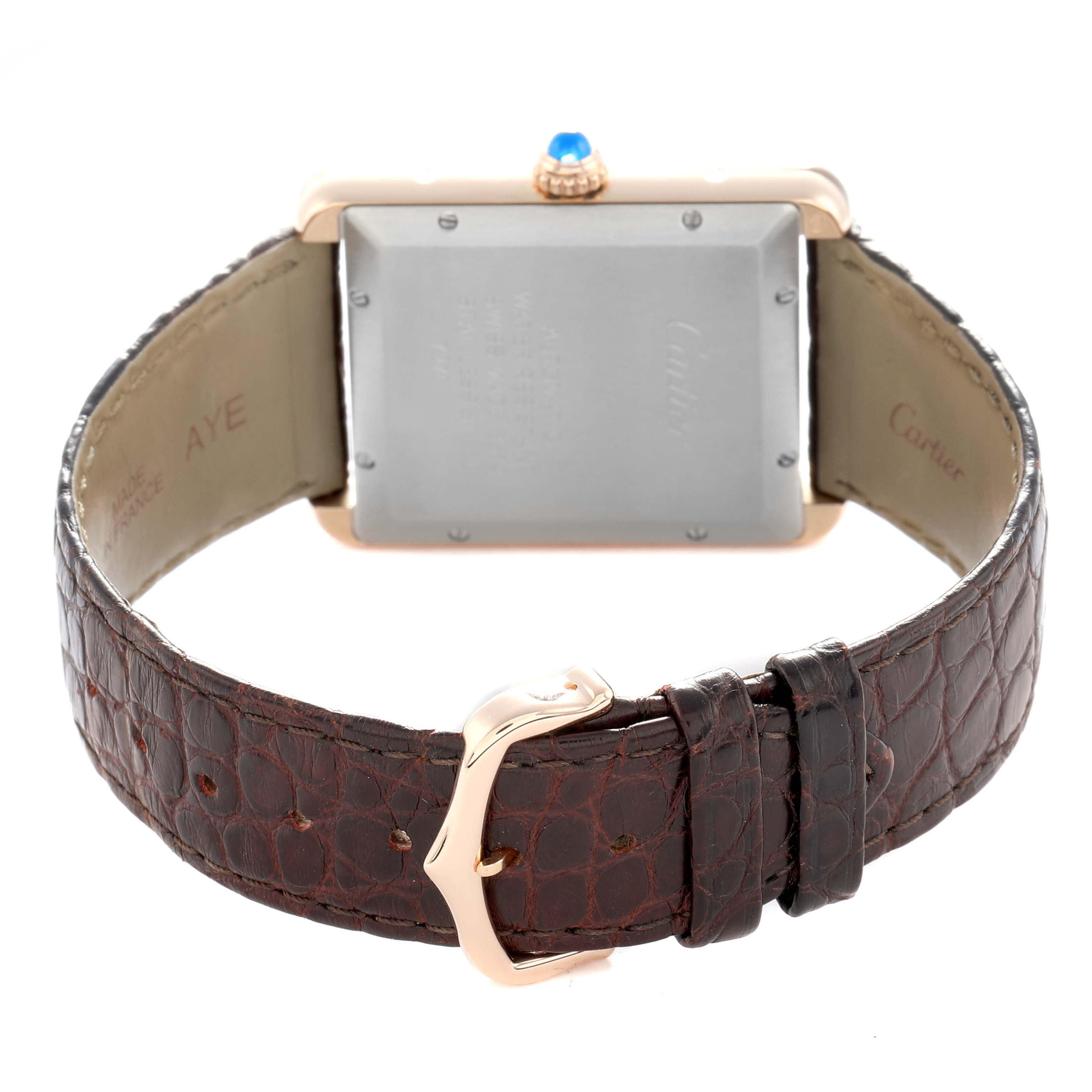 The image shows the back view of a Cartier Tank Solo W5200026 Men
s Rose Gold Silver Dial watch with its leather strap and buckle visible.