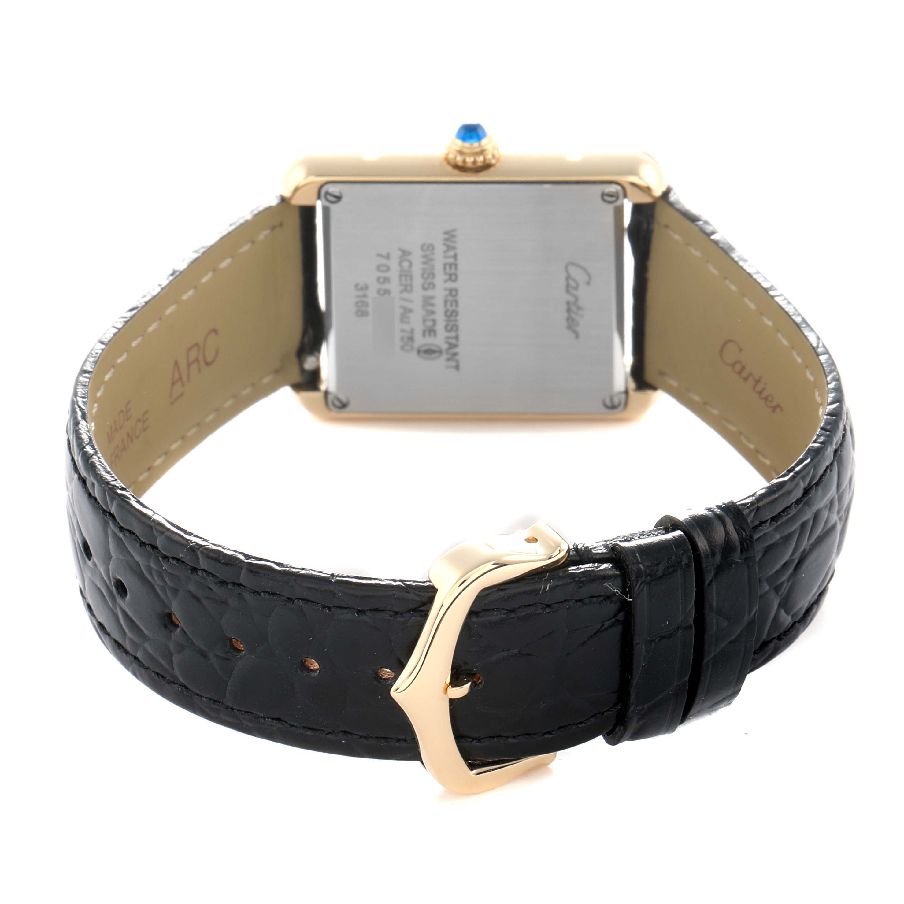 The image shows the back of the Cartier Tank Solo W5200002 Women
s Yellow Gold Black Dial watch, highlighting the case back and leather strap with buckle.