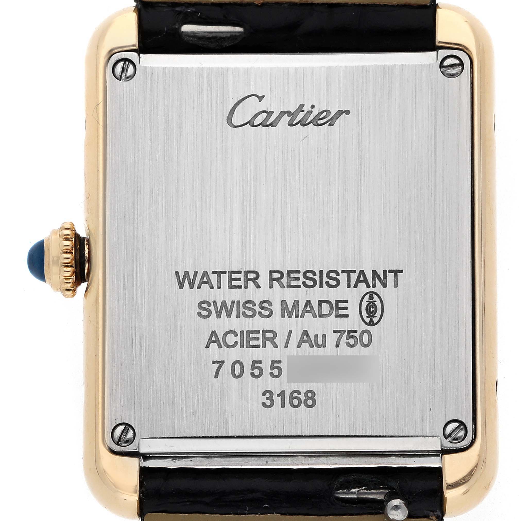 The image shows the back case of a Cartier Tank Solo W5200002 Women
s Yellow Gold Black Dial watch, highlighting the screws and inscriptions.