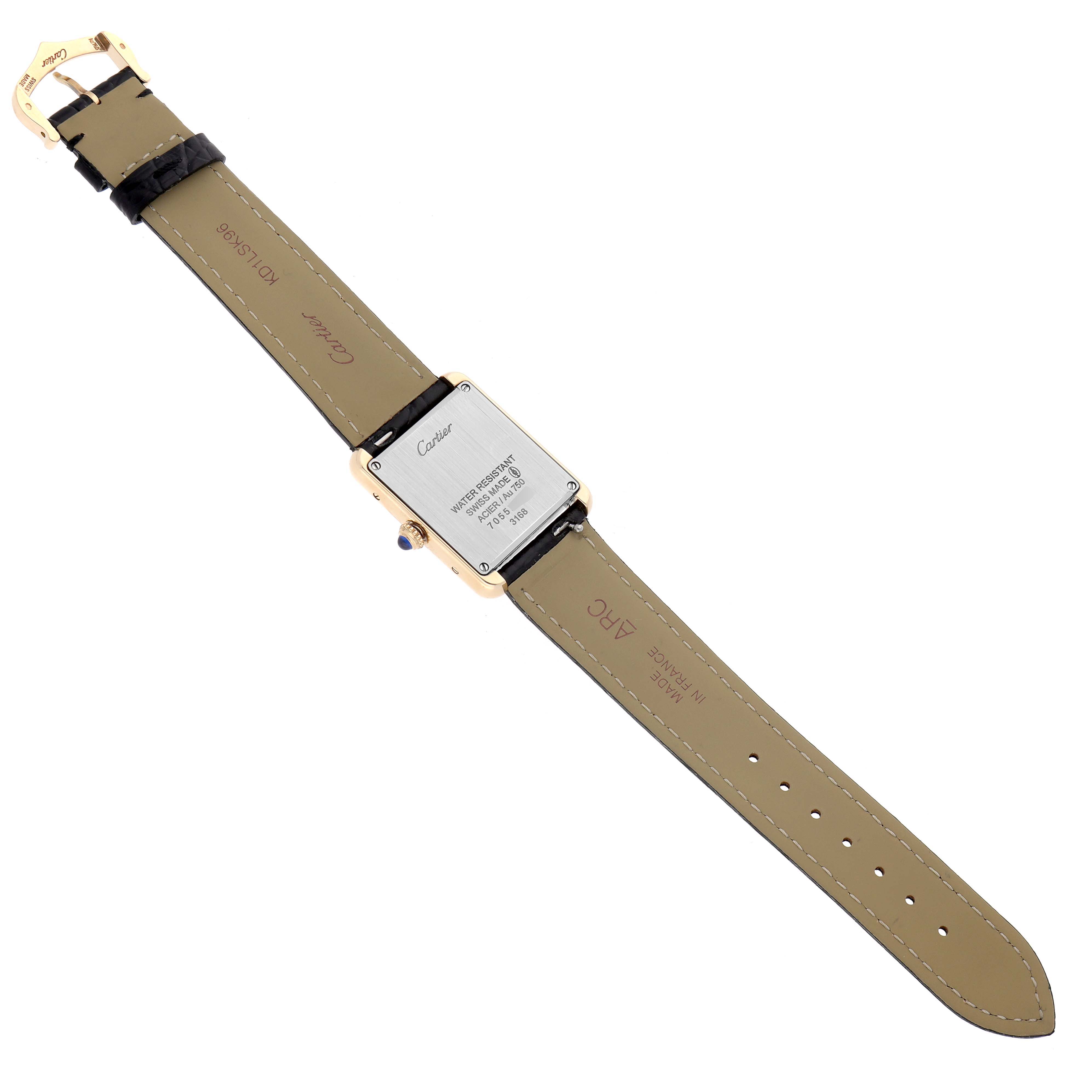 The image shows the back side of a Cartier Tank Solo W5200002 Women
s Yellow Gold Black Dial watch, highlighting the case back, leather strap, and buckle.