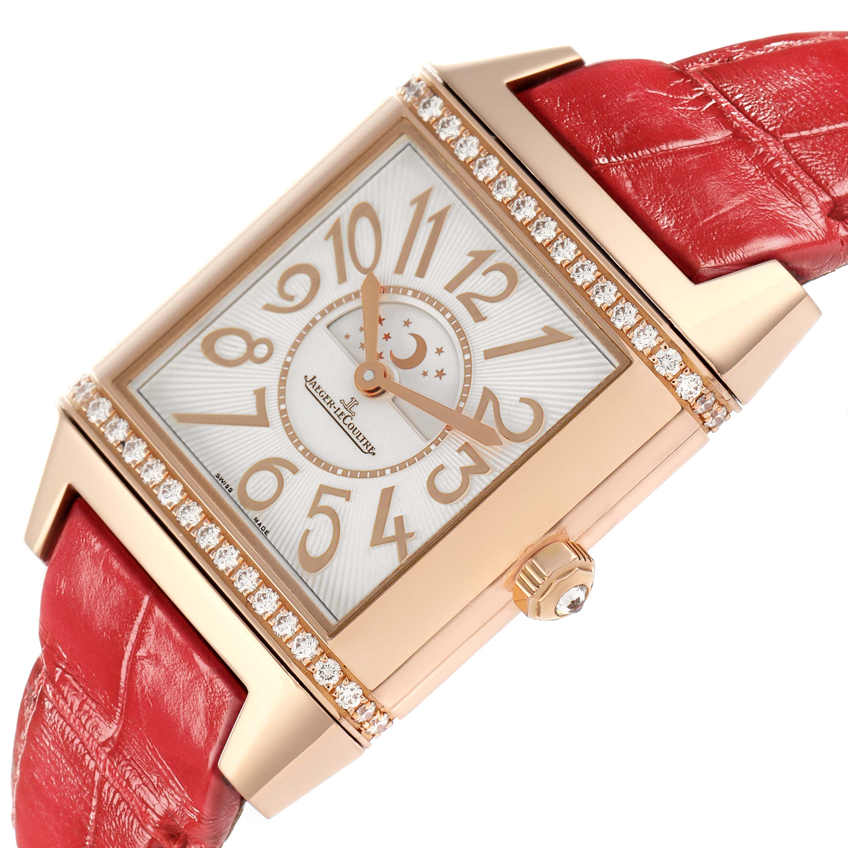 The Jaeger-LeCoultre Reverso watch is angled to show the face, red leather strap, diamond-set case, and crown.