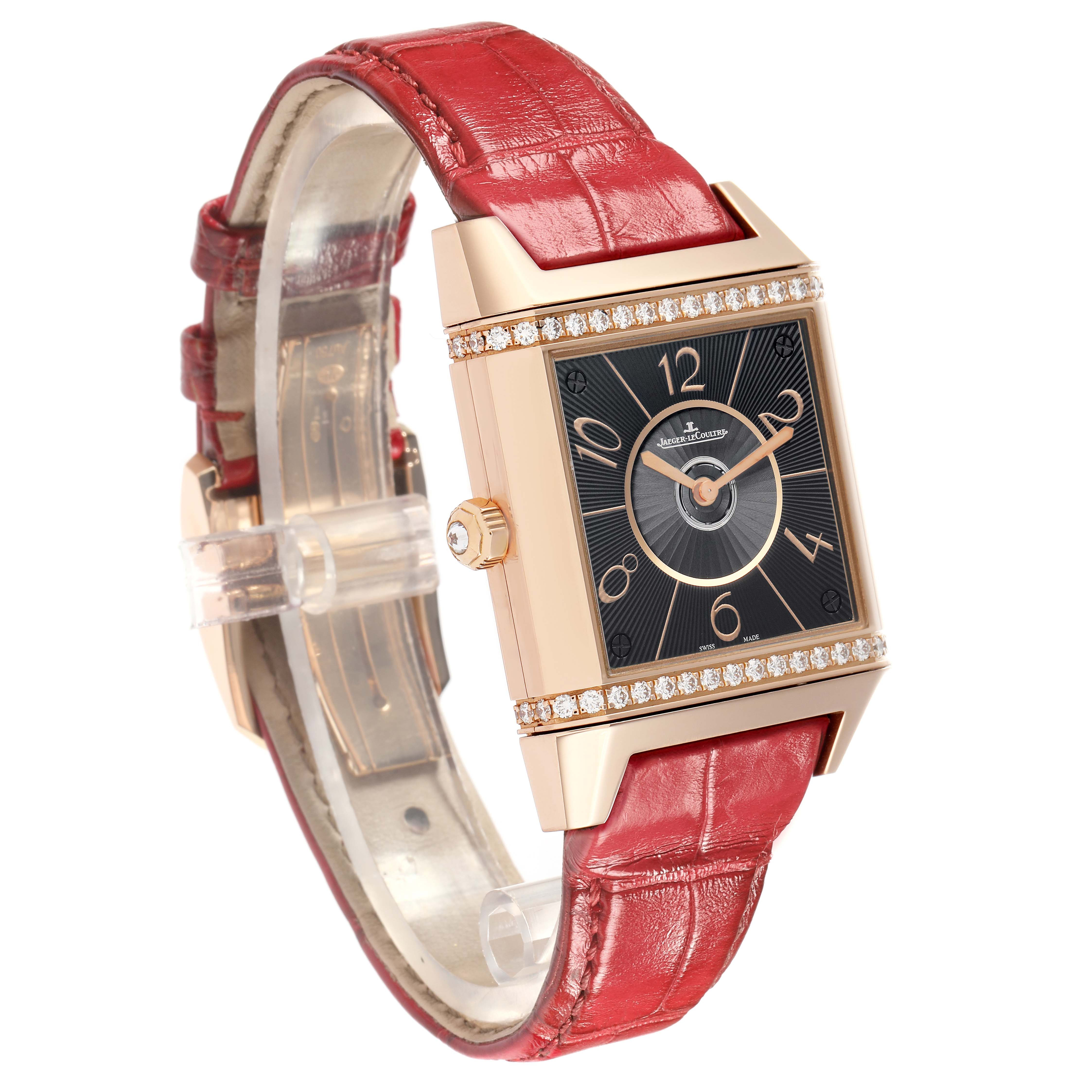 The Jaeger LeCoultre Reverso Q7052421 Women
s Rose Gold Silver Dial watch is shown at a three-quarter angle, displaying the face, crown, and red leather strap.