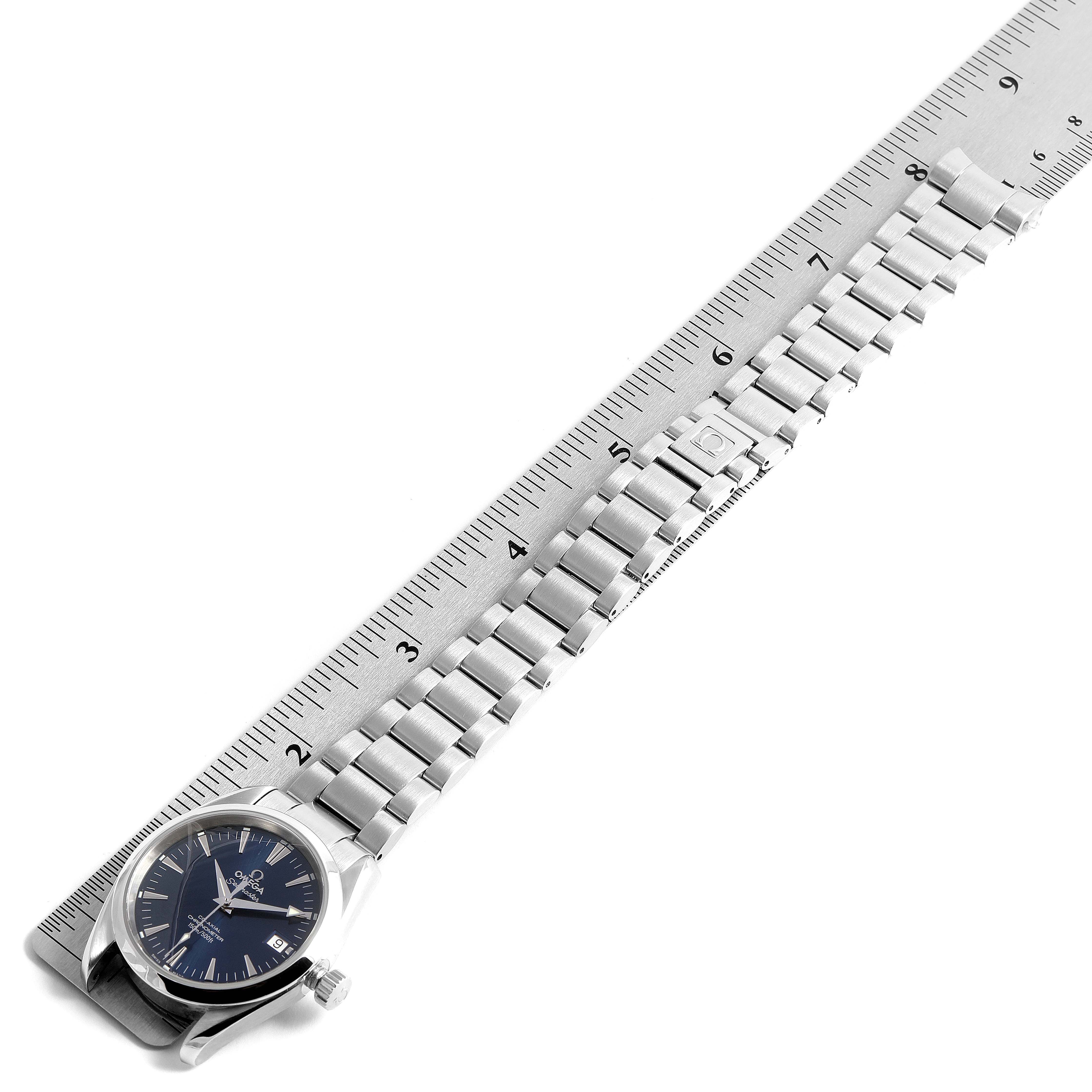 The Omega Aqua Terra 2504.80.00 Men
s Stainless Steel Blue Dial 2504.80.00 Men
s Stainless Steel Blue Dial watch is shown from a top-down angle, featuring the face and the entire metal bracelet on a ruler.