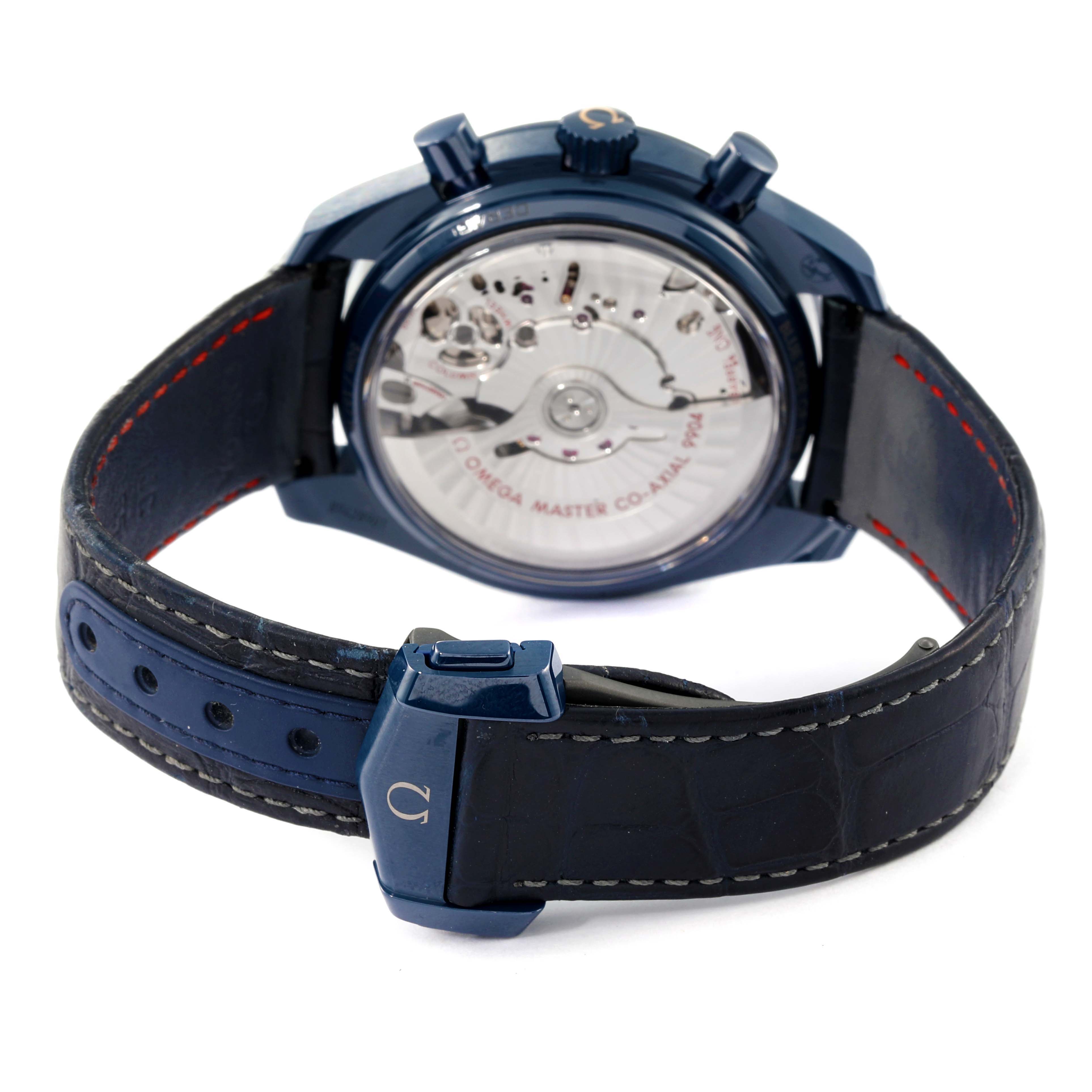 The image shows the back view of an Omega Speedmaster 304.93.44.52.03.002 Men's Ceramic Blue Dial 304.93.44.52.03.002 Men's Ceramic Blue Dial watch, highlighting the transparent case back and the leather strap with a clasp.