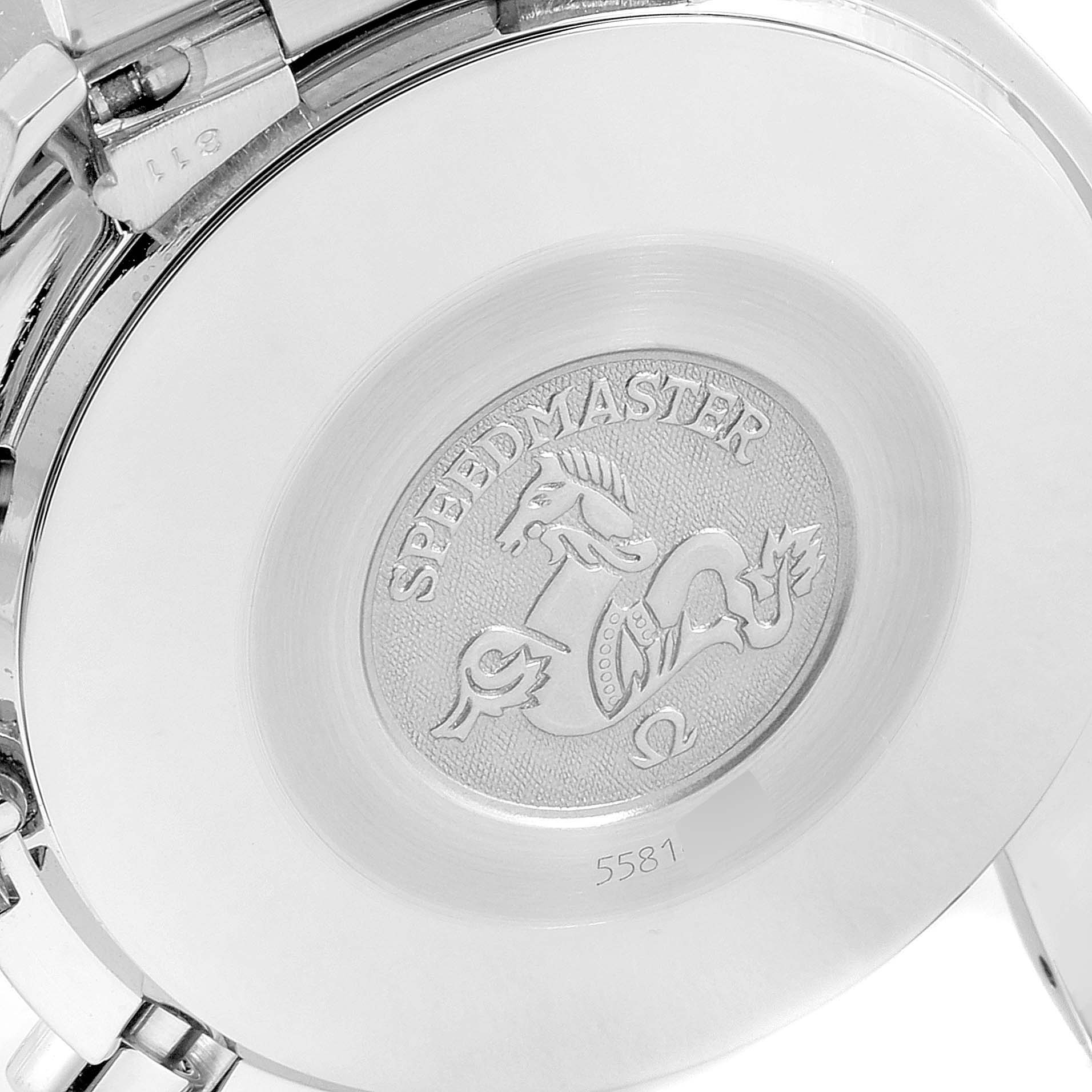 The image shows the back case of an Omega Speedmaster 3510.61.00 Men
s Stainless Steel Red Dial 3510.61.00 Men
s Stainless Steel Red Dial watch with its emblem and some engraved text.