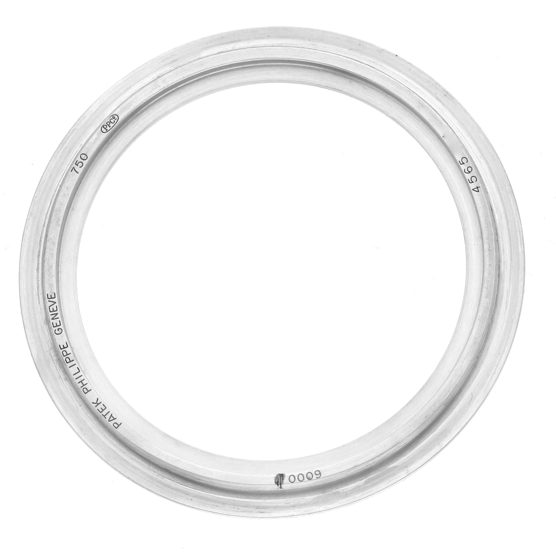 The image shows a top view of a Patek Philippe Calatrava 6000G Men
s White Gold Grey Dial watch bezel with engraved markings.