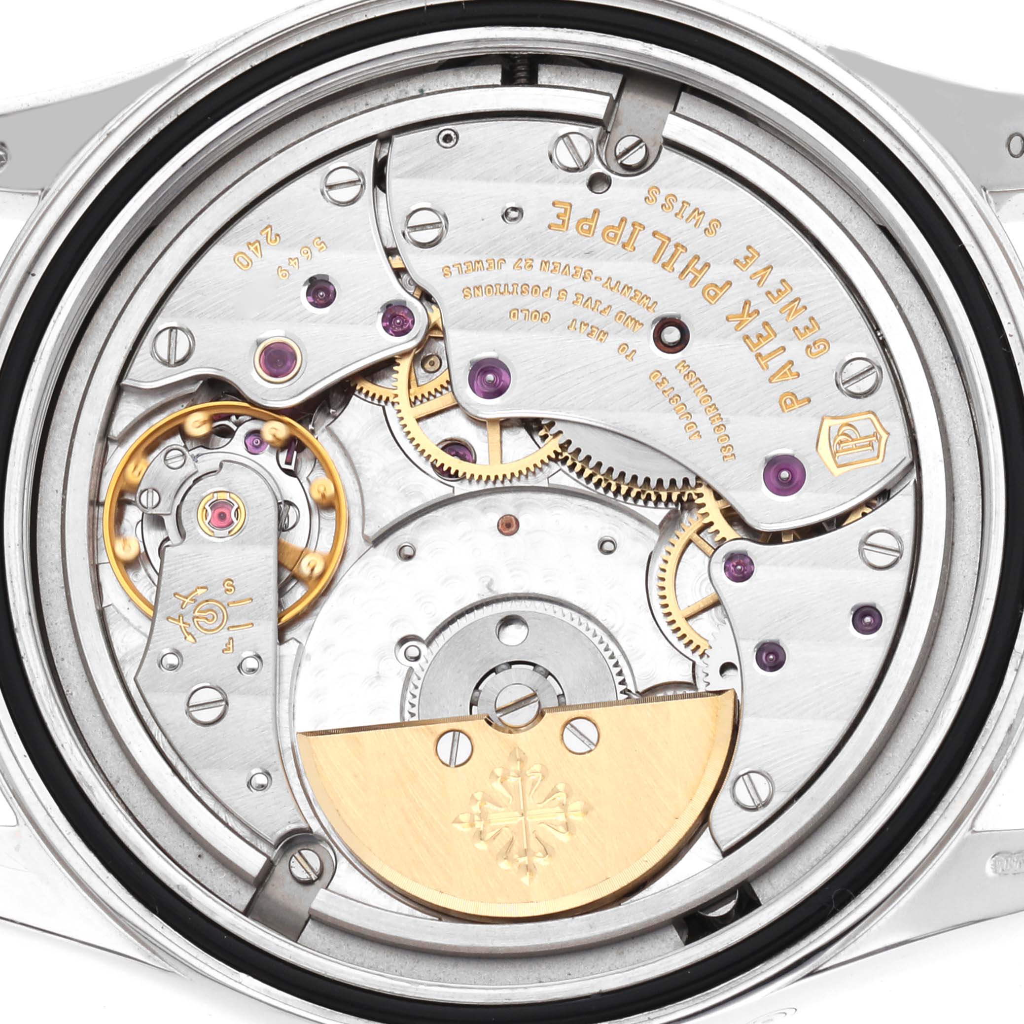 The image shows the movement of a Patek Philippe Calatrava 6000G Men
s White Gold Grey Dial watch from a rear angle, highlighting gears and engravings.