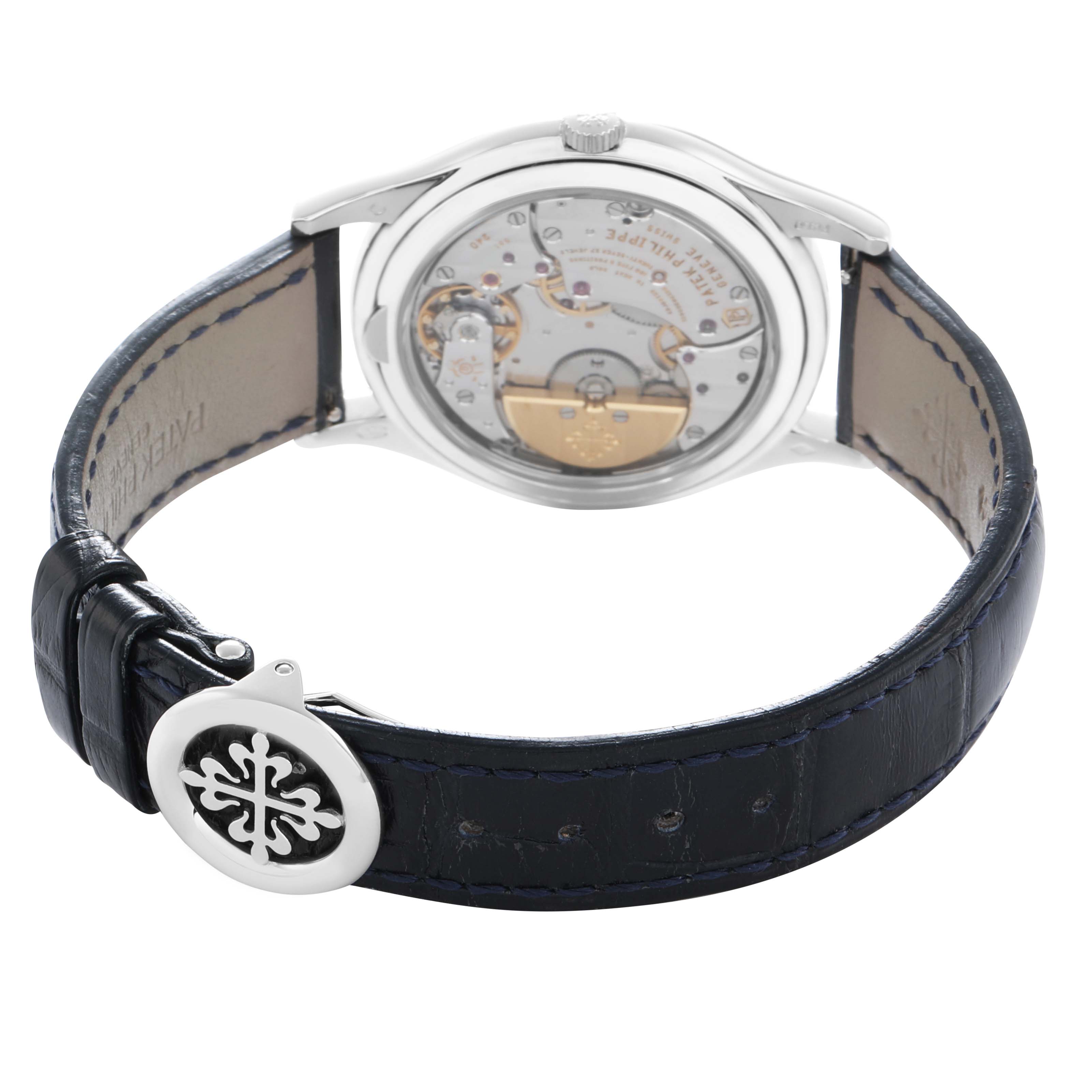 The Patek Philippe Complications 5140P Men
s Platinum Blue Dial watch is shown from the back, highlighting the visible movement and a leather strap with a logo clasp.