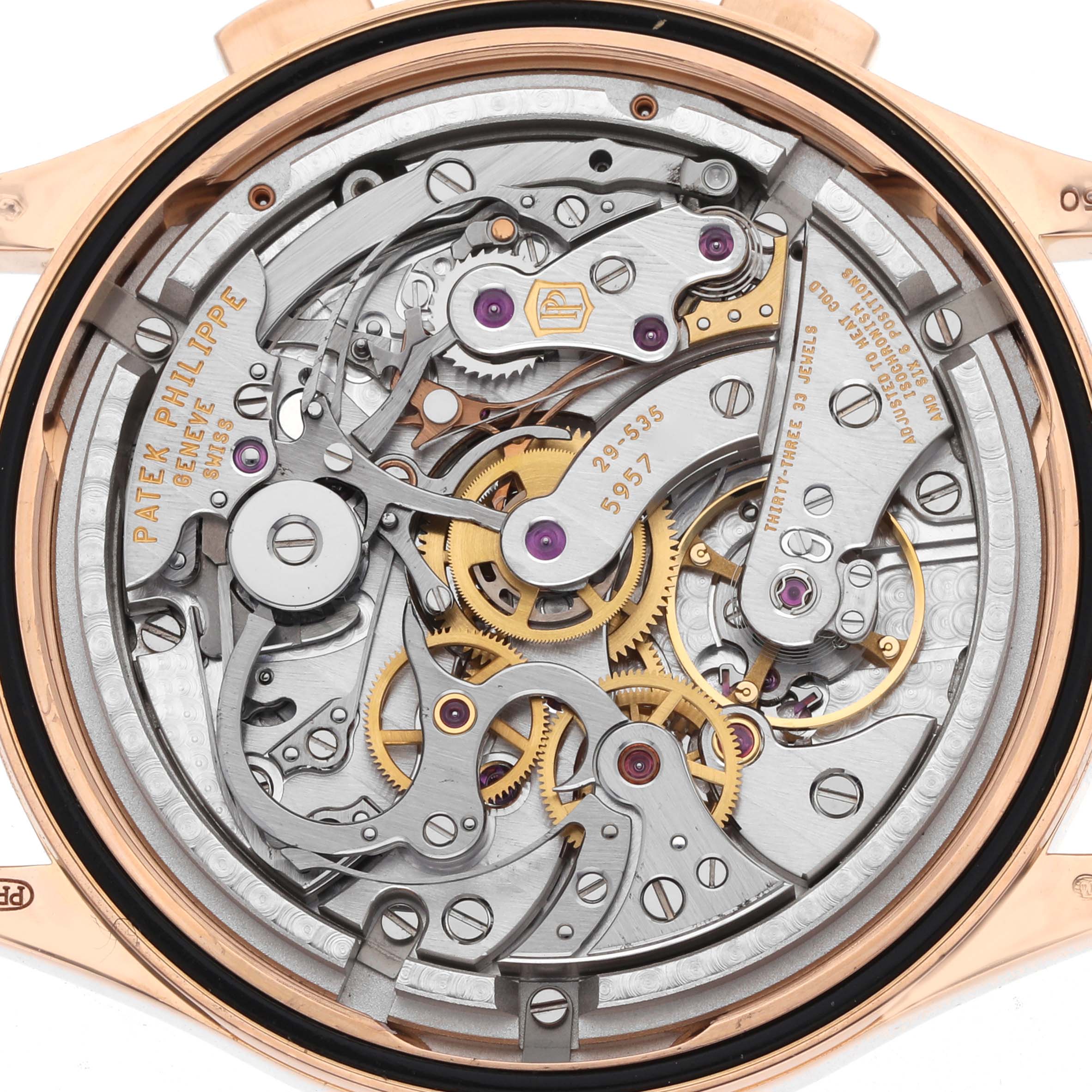 The image shows the intricate back movement of a Patek Philippe Complications 5170R Men
s Rose Gold Silver Dial watch, highlighting gears and mechanisms.