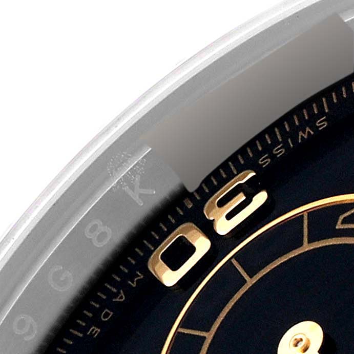 The image shows a partial close-up of the dial and bezel of a Rolex Daytona 116503 Men's Steel and Gold (two tone) Black Dial 116503 Men's Steel and Gold (two tone) Black Dial watch, highlighting the numbers and minute markers.