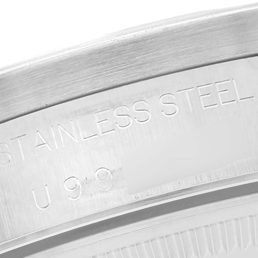 This close-up image shows the engraved stainless steel text on the case back of a Rolex Date 15210 Men
s Stainless Steel Silver Dial 15210 Men
s Stainless Steel Silver Dial model watch.