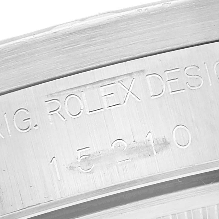 The image shows a close-up of the side of a Rolex Date 15210 Men
s Stainless Steel Silver Dial 15210 Men
s Stainless Steel Silver Dial watch case, featuring engraved model and brand details.