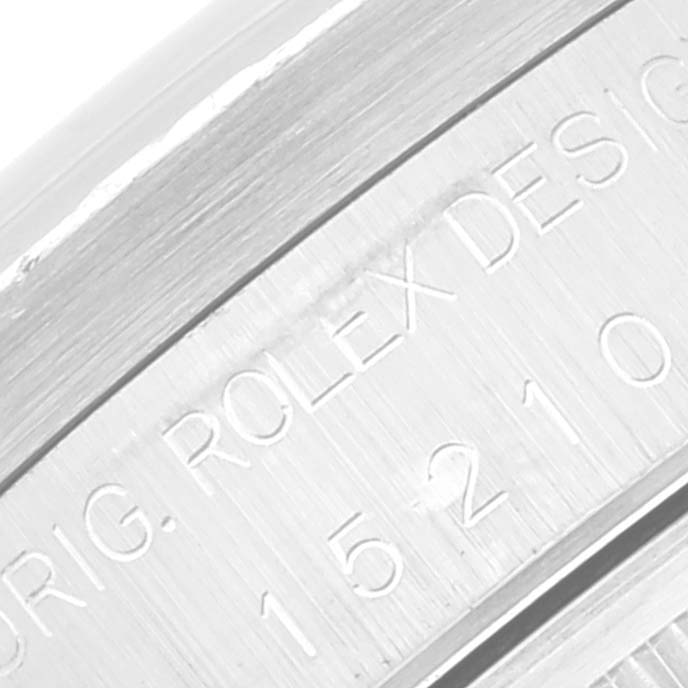 This close-up image shows the etched brand markings on the side of a Rolex Date 15210 Men's Stainless Steel White Dial 15210 Men's Stainless Steel White Dial model watch.