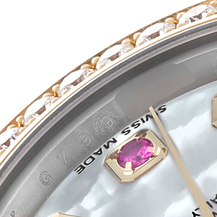 This image shows a close-up of the bezel, crystal, and gemstone hour marker on the face of a Rolex Datejust 179383 Women's Steel and Gold (two tone) Mother of Pearl Dial 179383 Women's Steel and Gold (two tone) Mother of Pearl Dial watch.