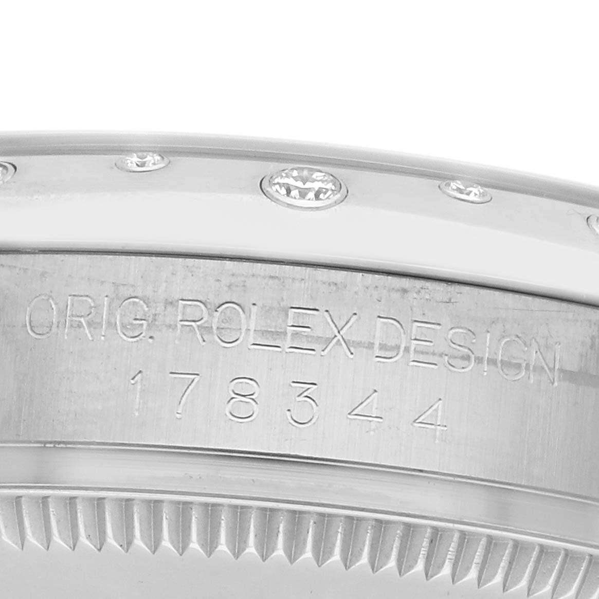 The image shows the side of a Rolex Mid-Size 178344 Women
s Stainless Steel Mother of Pearl Dial watch case with the model number 178344 engraved, including bezel details.