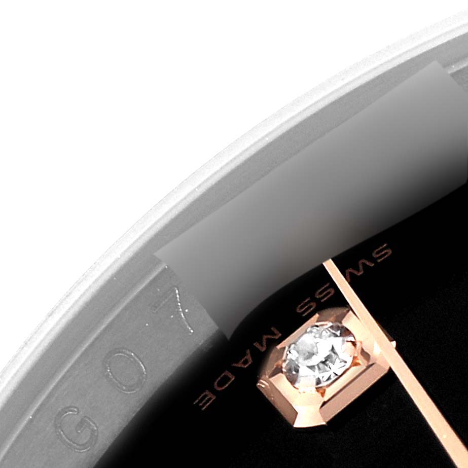 The image shows a close-up view of the Rolex Datejust 116231 Men's Steel and Gold (two tone) Black Dial 116231 Men's Steel and Gold (two tone) Black Dial watch dial, specifically a diamond marker and part of the inscription.