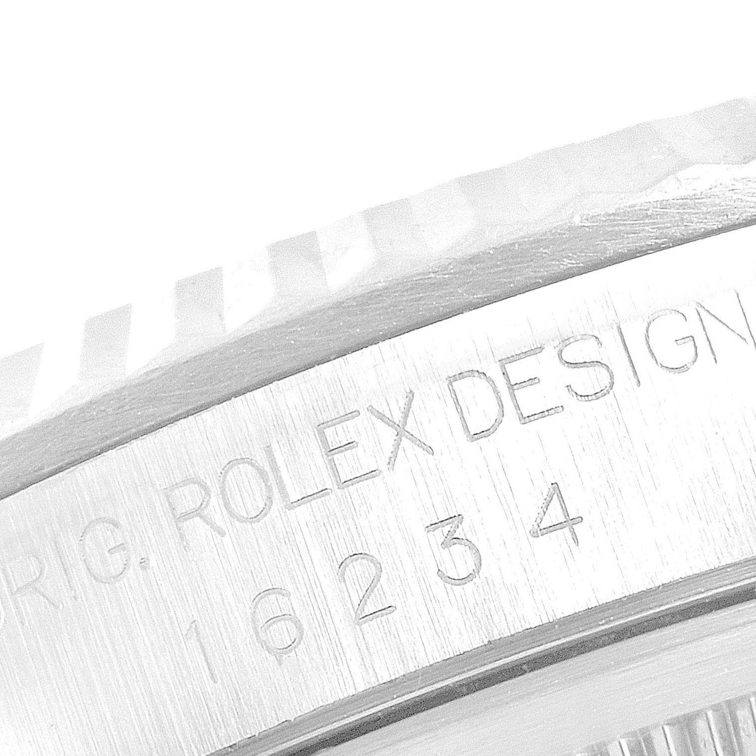 This close-up angle of the Rolex Datejust 16234 Men's Stainless Steel Blue Dial 16234 Men's Stainless Steel Blue Dial shows part of the bezel and engraved reference number.