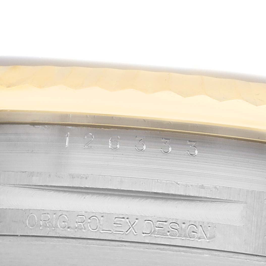 The image shows a close-up of the bezel and inner rim of a Rolex Datejust 41 126333 Men
s Steel and Gold (two tone) Grey Dial, focusing on engravings.