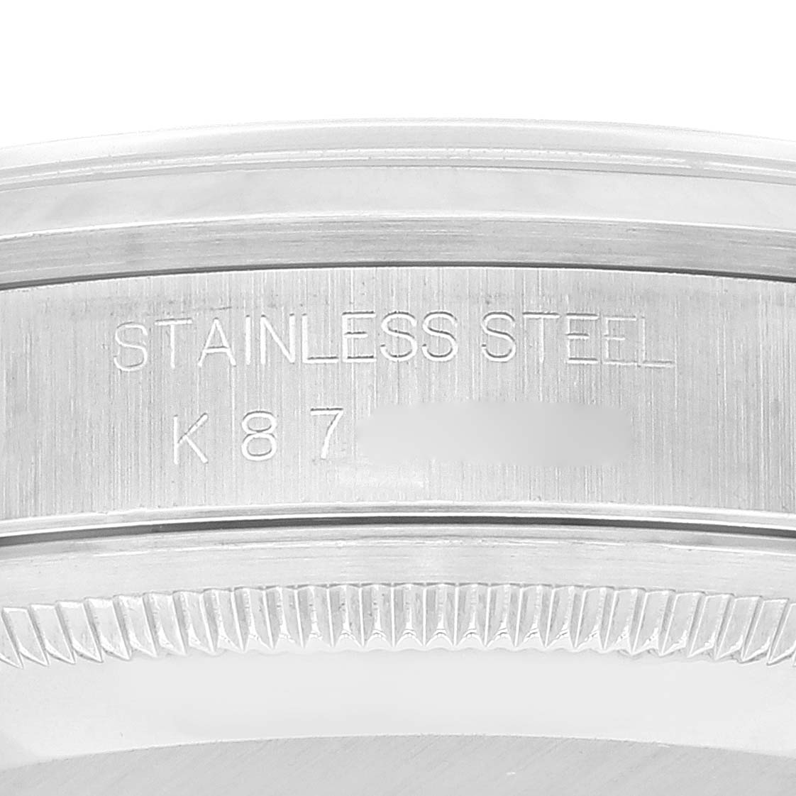The image shows the engraved serial number and "Stainless Steel" text on the bezel edge of a Rolex Datejust 16200 Men's Stainless Steel Blue Dial 16200 Men's Stainless Steel Blue Dial model watch.