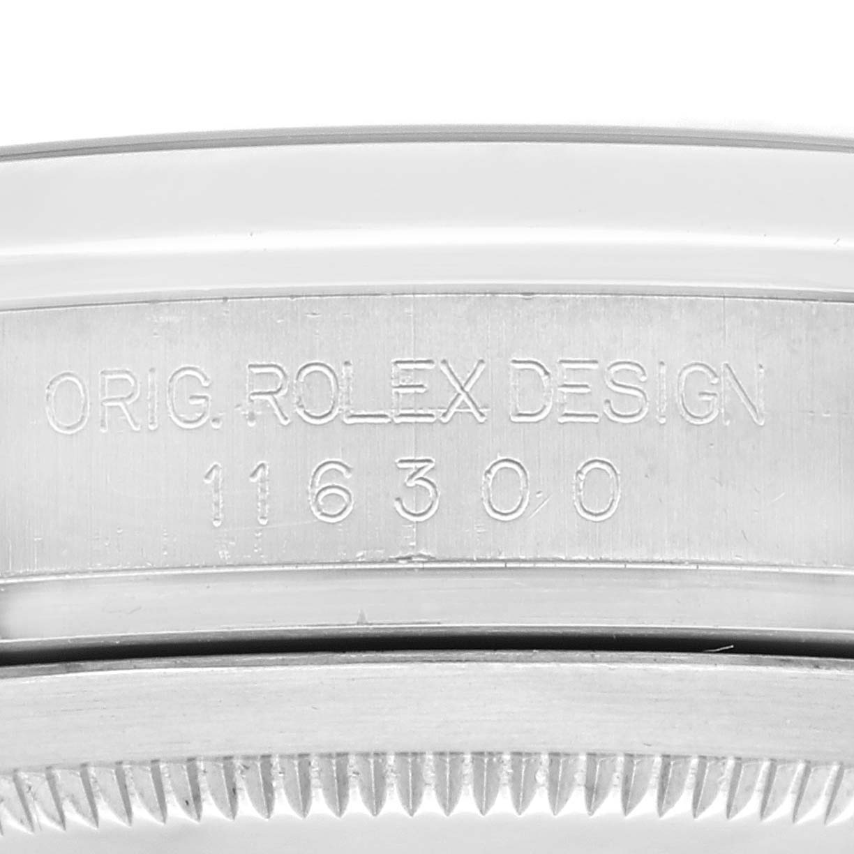 The image shows a close-up of the side of a Rolex Datejust 41 116300 Men
s Stainless Steel Blue Dial 116300 Men
s Stainless Steel Blue Dial watch case with engravings and part of the bezel.