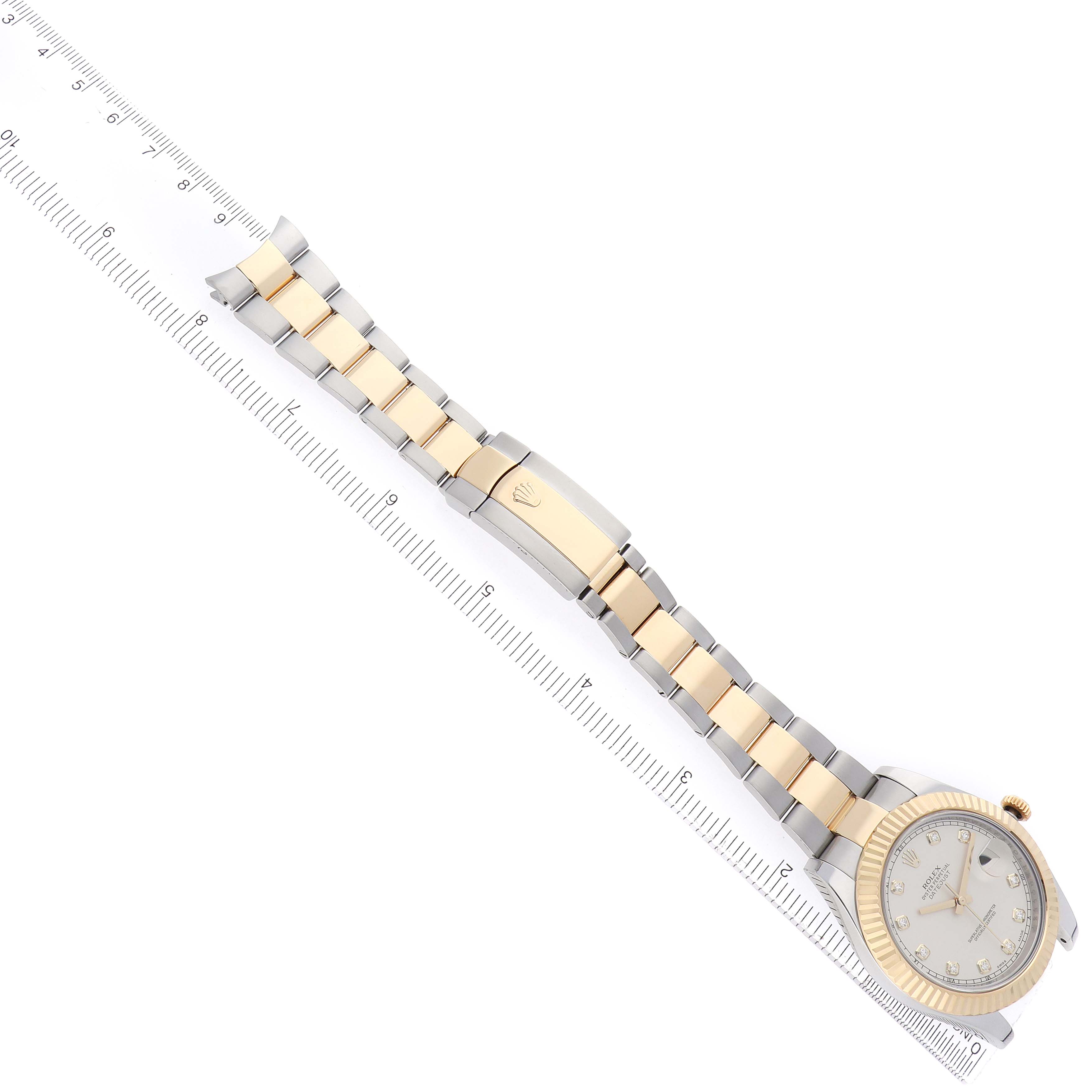 The Rolex Datejust 41 116333 Men
s Steel and Gold (two tone) Silver Dial is shown from a top view, displaying the full bracelet, clasp, and case with a ruler beside it.