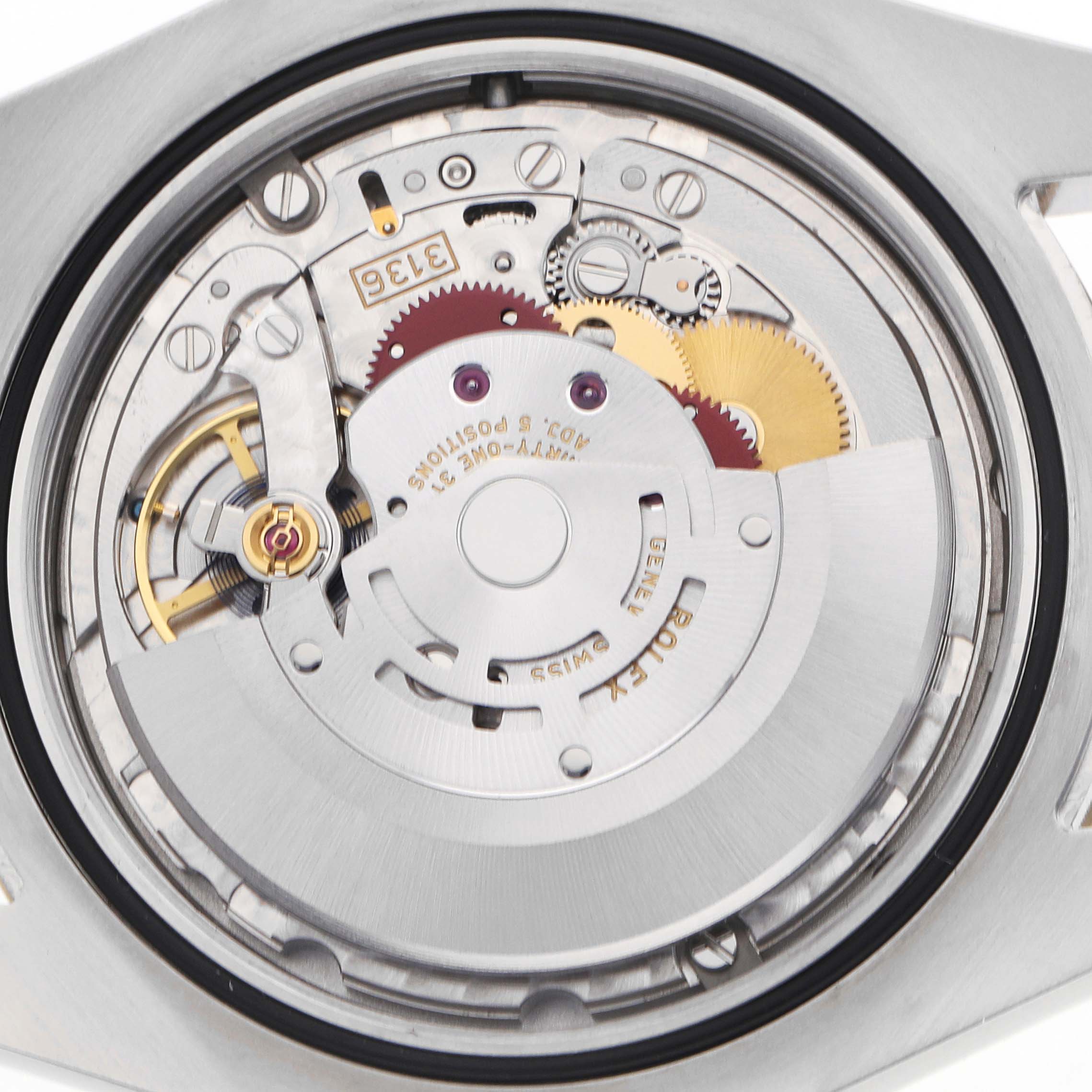 The image shows a close-up view of the Rolex Datejust 41 116333 Men
s Steel and Gold (two tone) Silver Dial
s movement, highlighting gears and the rotor mechanism.