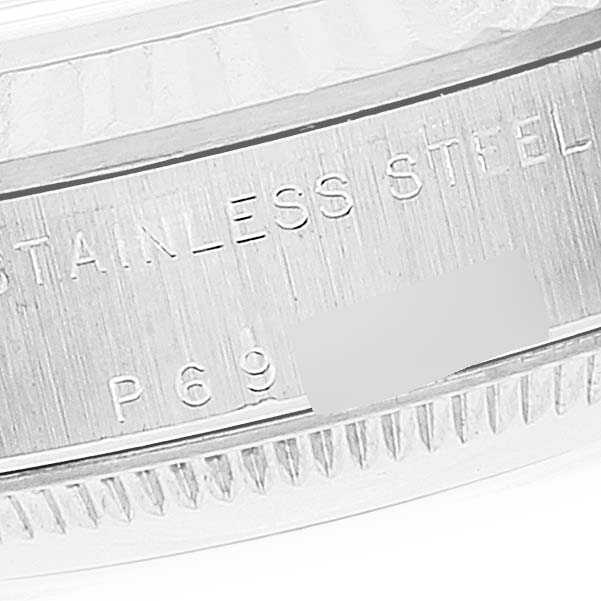 This is a close-up image of the case back and bezel edge of a mid-size Rolex watch showing the "STAINLESS STEEL" inscription.