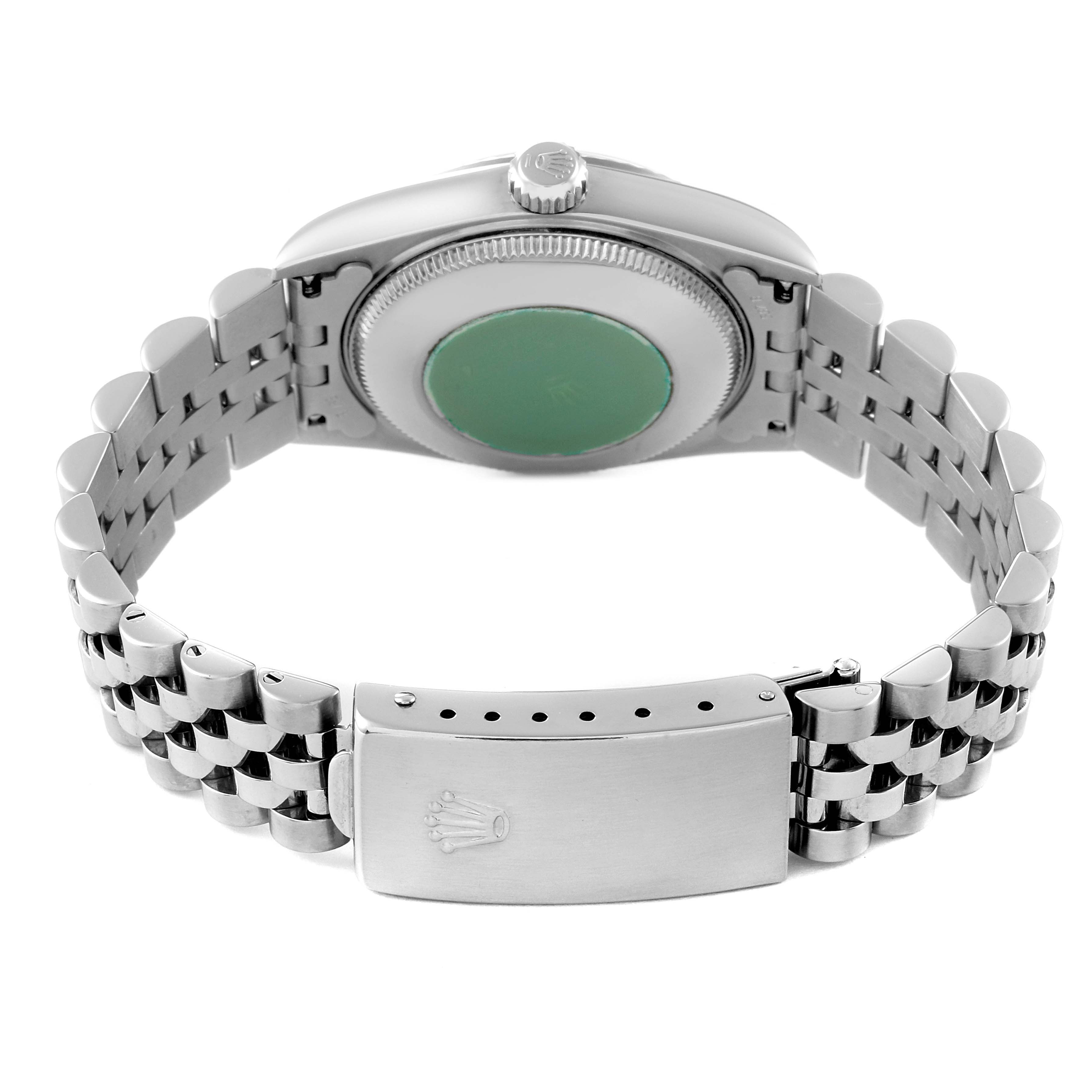 This image shows the back case and bracelet clasp of a Mid-Size Rolex watch, viewed from an angle that highlights the case back and band.