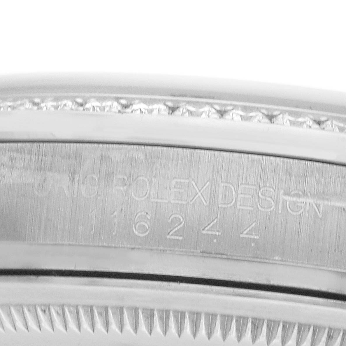 The image shows the side view of a Rolex Datejust 116244 Men
s Stainless Steel Mother of Pearl Dial, focusing on the engraved case edge with the model number visible.