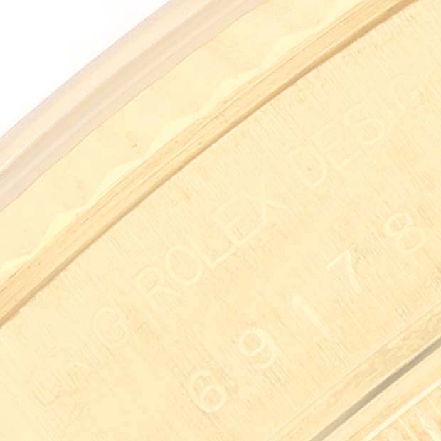 This image shows a close-up of the engraved details on the outer rim of a Rolex President 69178 Women's Yellow Gold Champagne Dial 69178 Women's Yellow Gold Champagne Dial watch case.