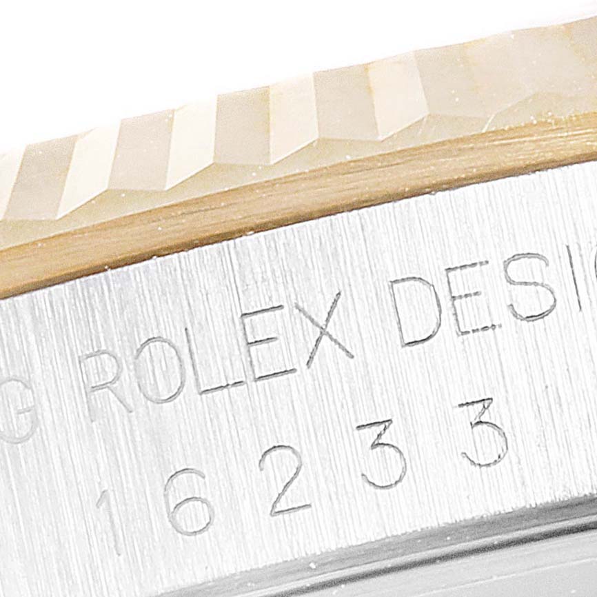 This image shows a close-up of the fluted bezel and part of the casing of a Rolex Datejust 16233 Men's Steel and Gold (two tone) Black Dial 16233 Men's Steel and Gold (two tone) Black Dial watch.