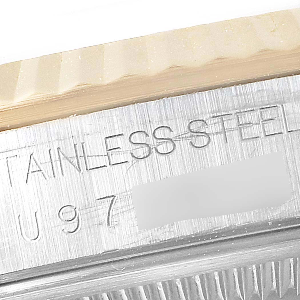 This image shows a close-up of the engraved serial number on the stainless steel case of a Rolex Datejust 16233 Men's Steel and Gold (two tone) Black Dial 16233 Men's Steel and Gold (two tone) Black Dial watch.