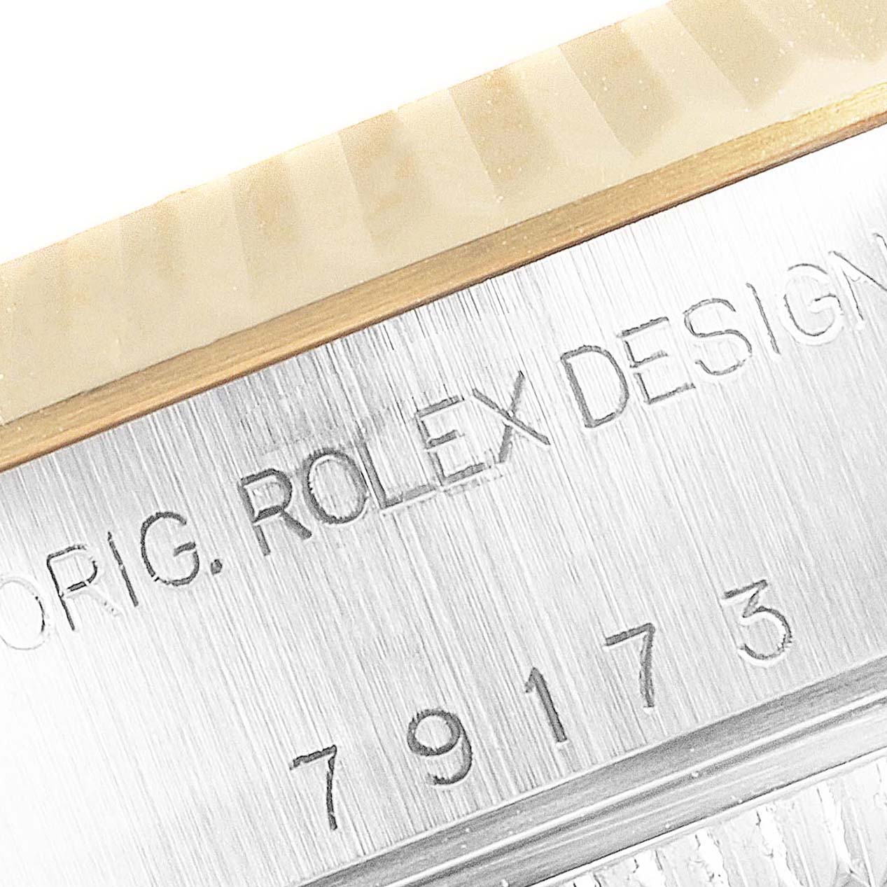 The image shows a close-up of the serial number area and part of the bezel of a Rolex Datejust 79173 Women's Steel and Gold (two tone) Blue Dial 79173 Women's Steel and Gold (two tone) Blue Dial watch.