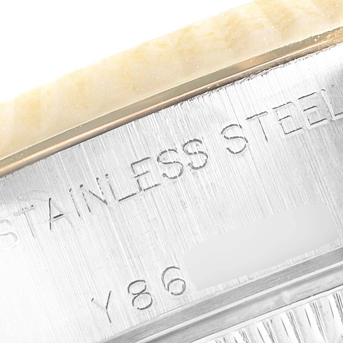 This image shows a close-up view of the stainless steel casing of a Rolex Datejust 79173 Women's Steel and Gold (two tone) Blue Dial 79173 Women's Steel and Gold (two tone) Blue Dial watch with partial engraving visible.