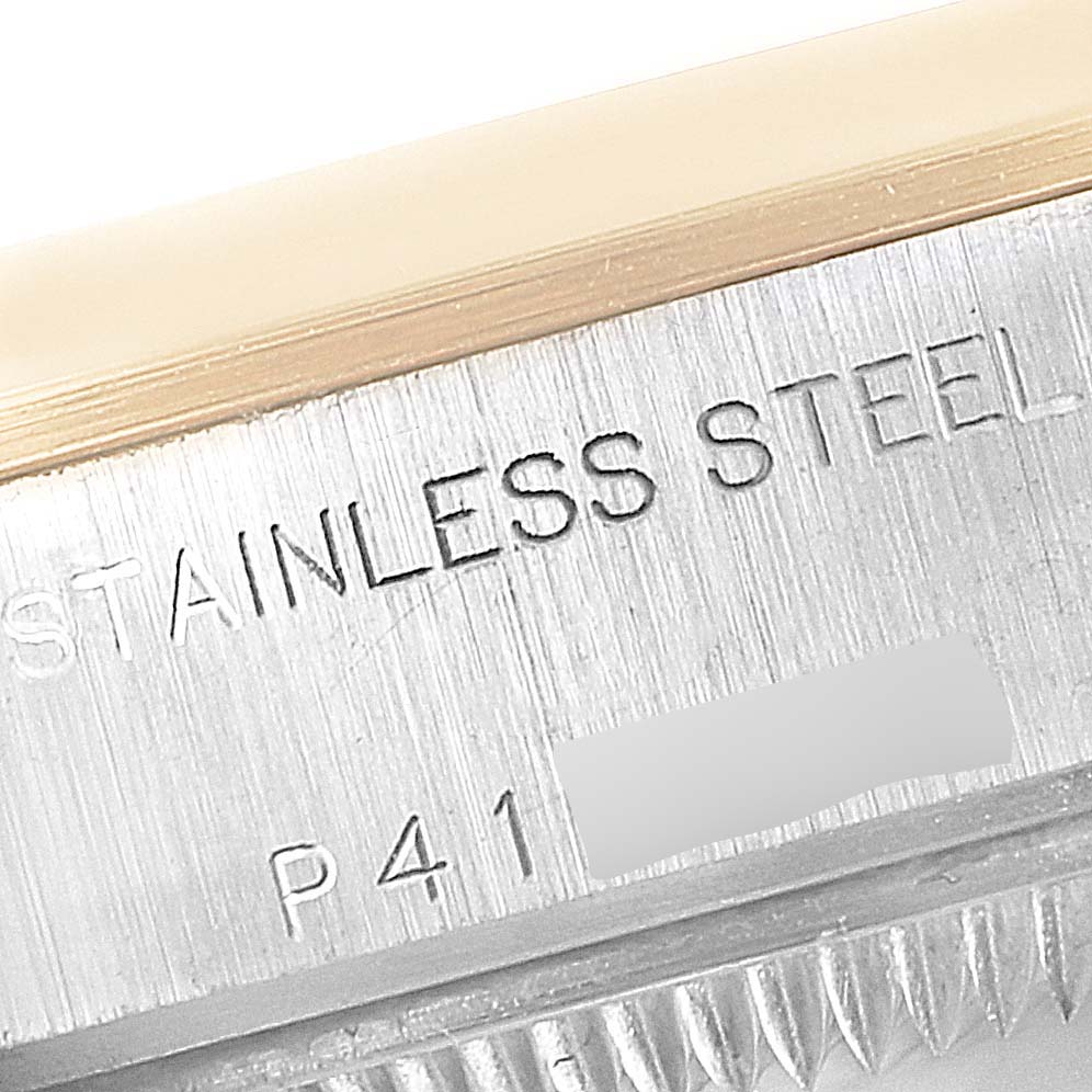 This image shows a close-up of the side engraving on a Rolex Datejust 79163 Women's Steel and Gold (two tone) Champagne Dial 79163 Women's Steel and Gold (two tone) Champagne Dial model, focusing on the "STAINLESS STEEL" marking.