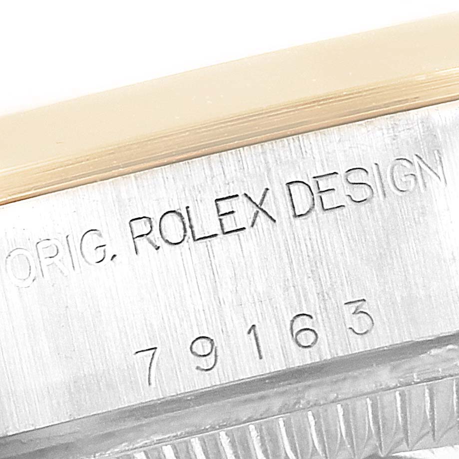 The image shows a close-up of the side of a Rolex Datejust 79163 Women's Steel and Gold (two tone) Champagne Dial 79163 Women's Steel and Gold (two tone) Champagne Dial watch, highlighting the engraved model number and "ORIG. ROLEX DESIGN" text.
