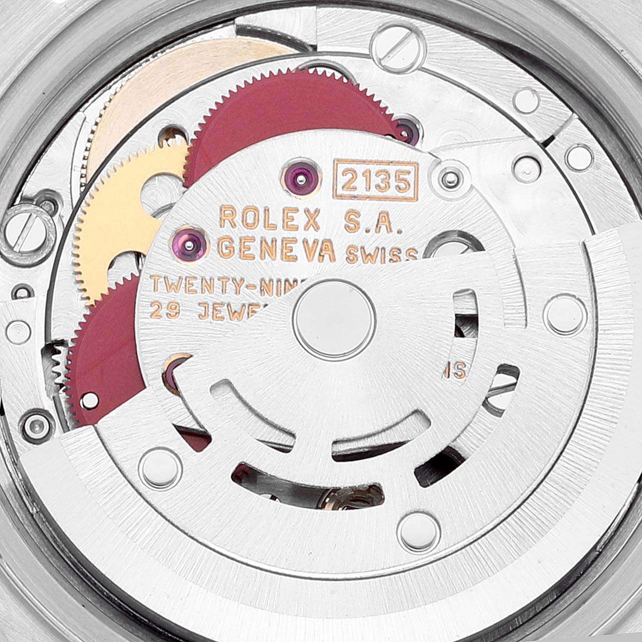This image shows a close-up view of the movement of a Rolex Datejust 69173 Women
s Steel and Gold (two tone) Champagne Dial 69173 Women
s Steel and Gold (two tone) Champagne Dial watch, highlighting the gears and engraved text.